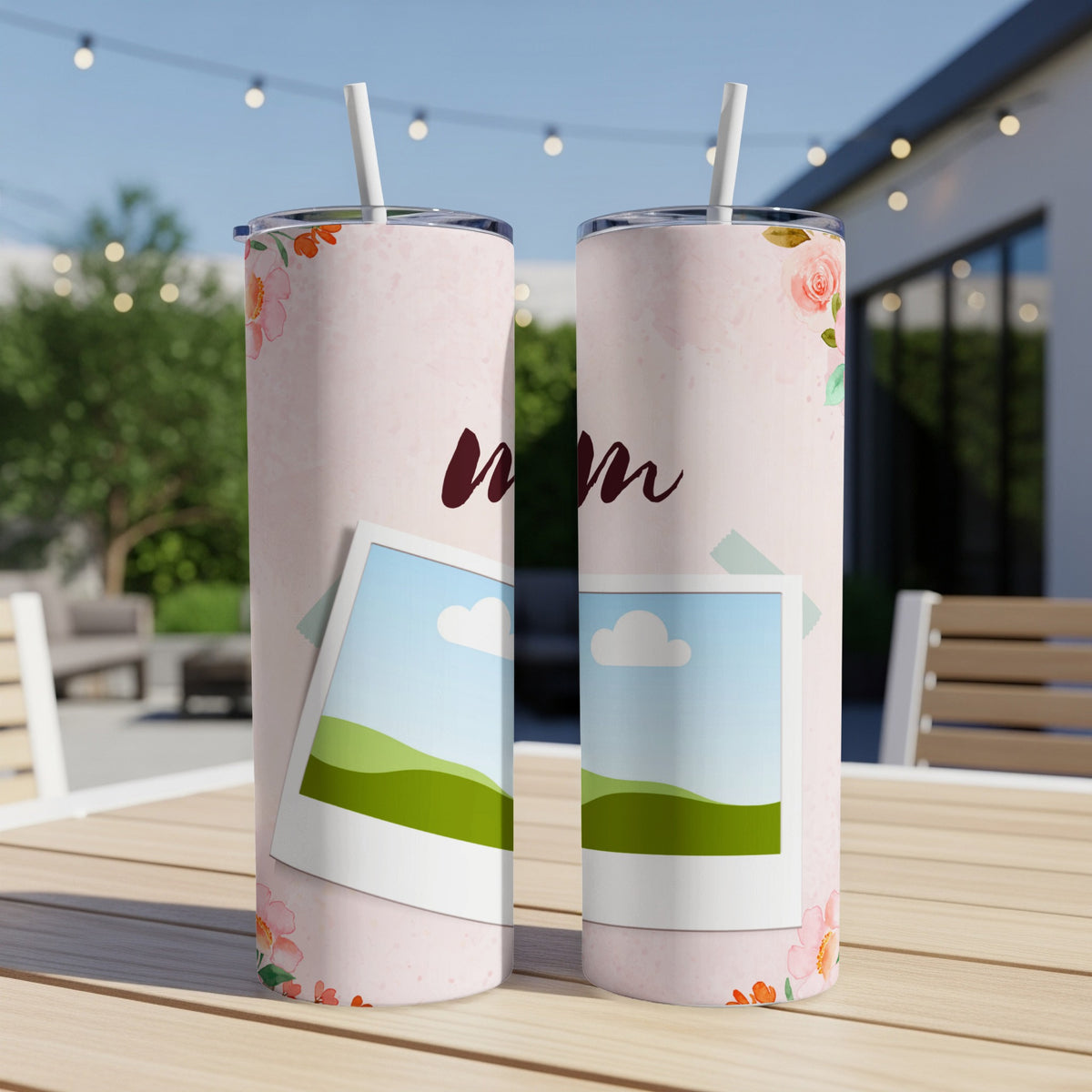 Two pink tumblers with floral accents and "Mom" text on a table.