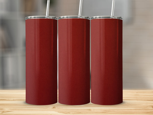 Three tall, narrow, dark red tumblers with white straws on a wooden surface.