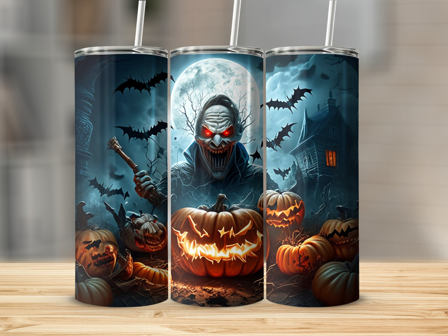 Three tumblers with a spooky Halloween design featuring a monster, bats, pumpkins, and a haunted house.