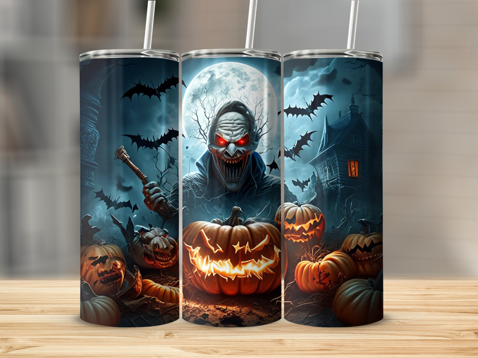 Three tumblers with a spooky Halloween design featuring a monster, bats, pumpkins, and a haunted house.