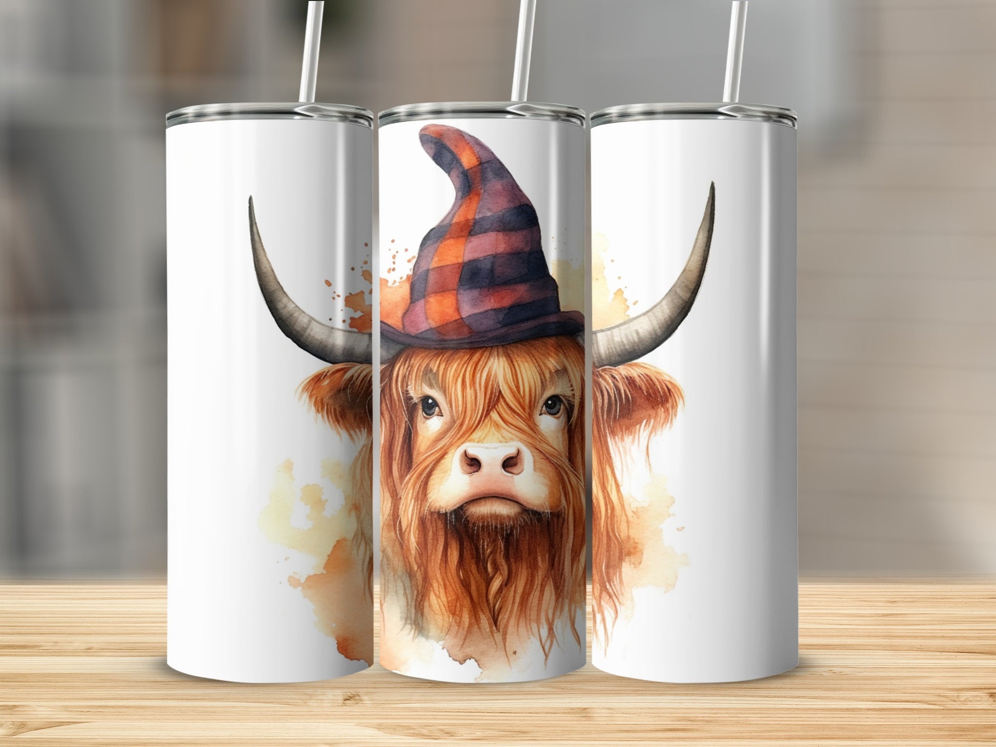 Highland cow with orange plaid witch hat on tumblers.