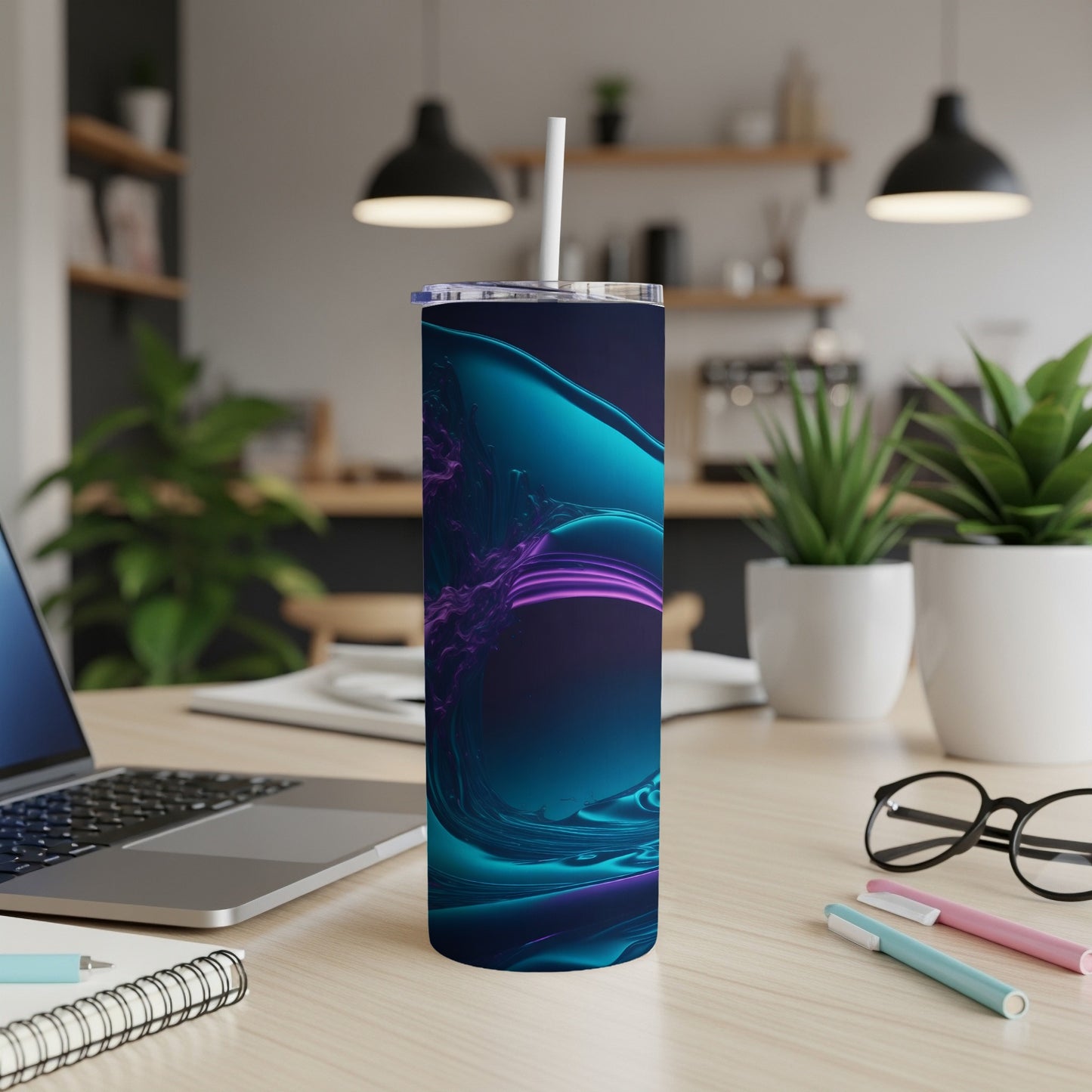 Teal and purple abstract design on a tall, slim tumbler with a straw.