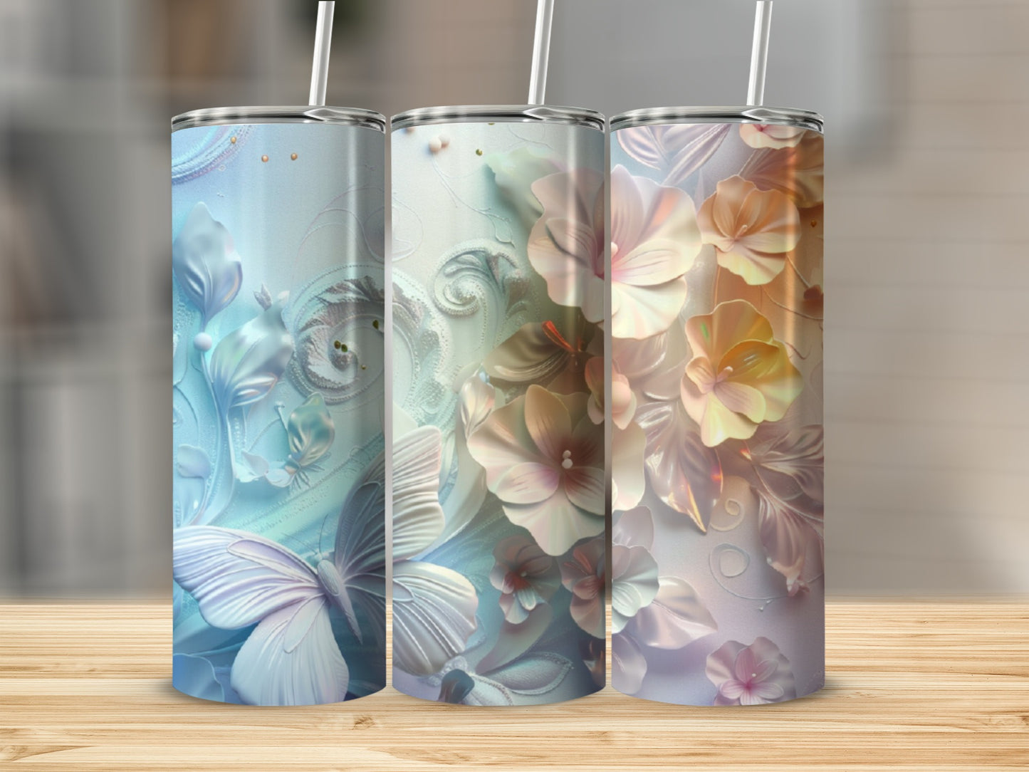 Three floral tumblers with butterflies and intricate patterns in blue, white, and peach.
