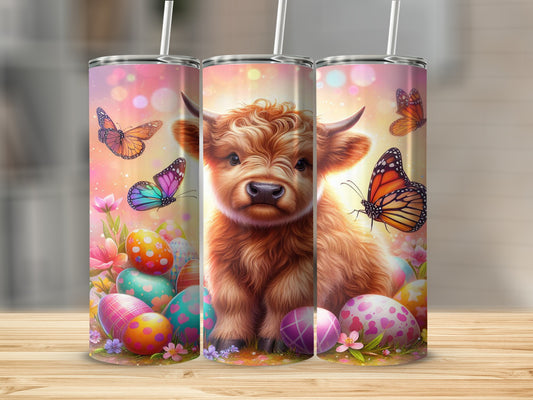 Fluffy Highland calf surrounded by colorful Easter eggs and butterflies.