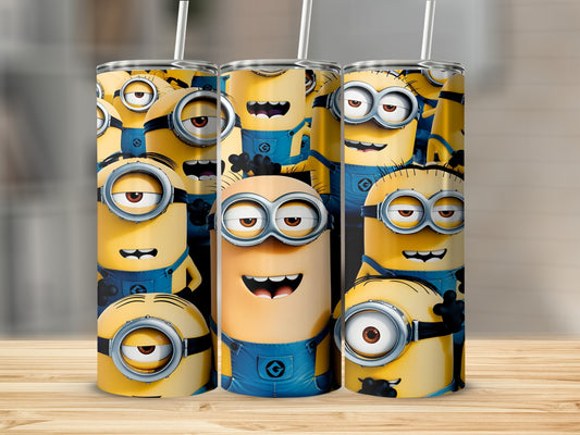 Three Minions cups with straws on a wooden surface.