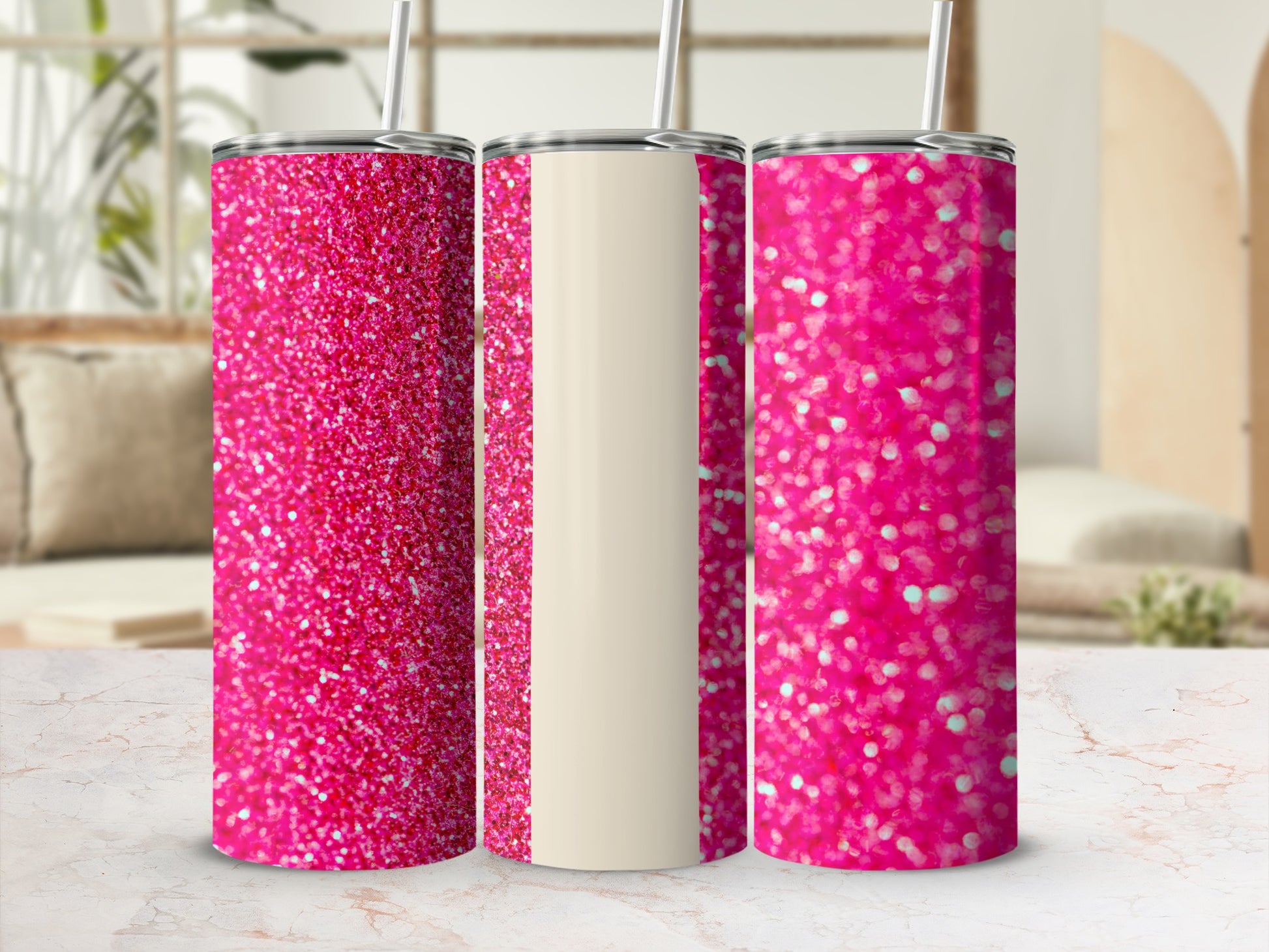 Three glittery pink tumblers with straws on a marble surface.