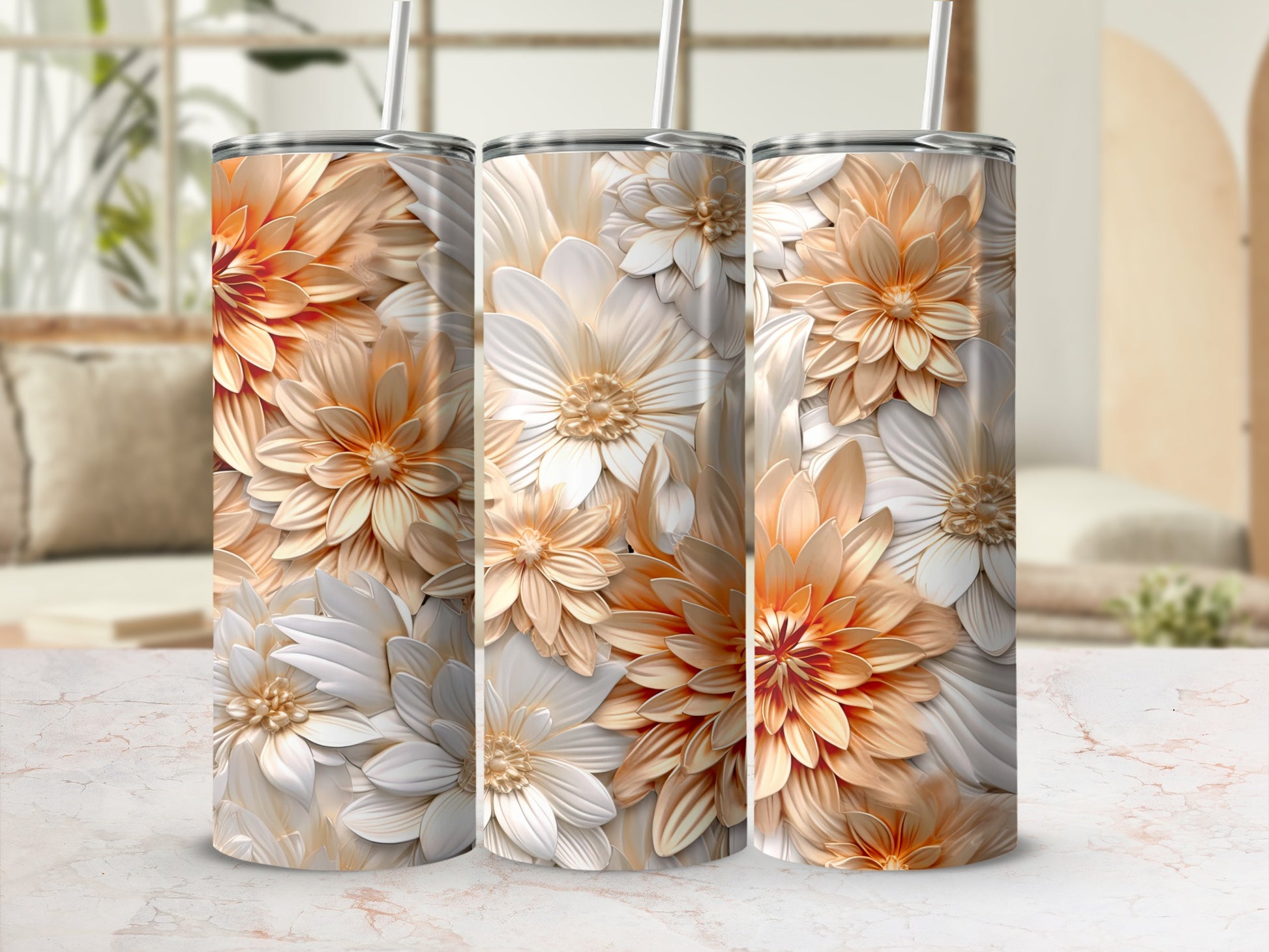 Three floral tumblers with white and orange petals and brown straws.