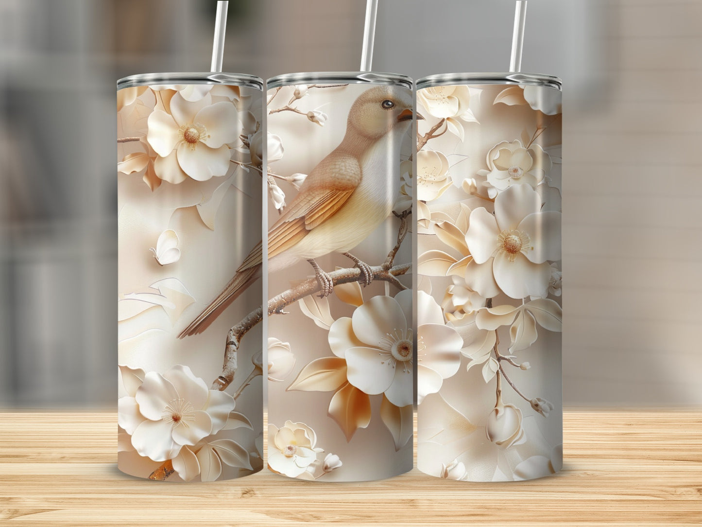 Three tumblers featuring a beige bird on a branch with white flowers.