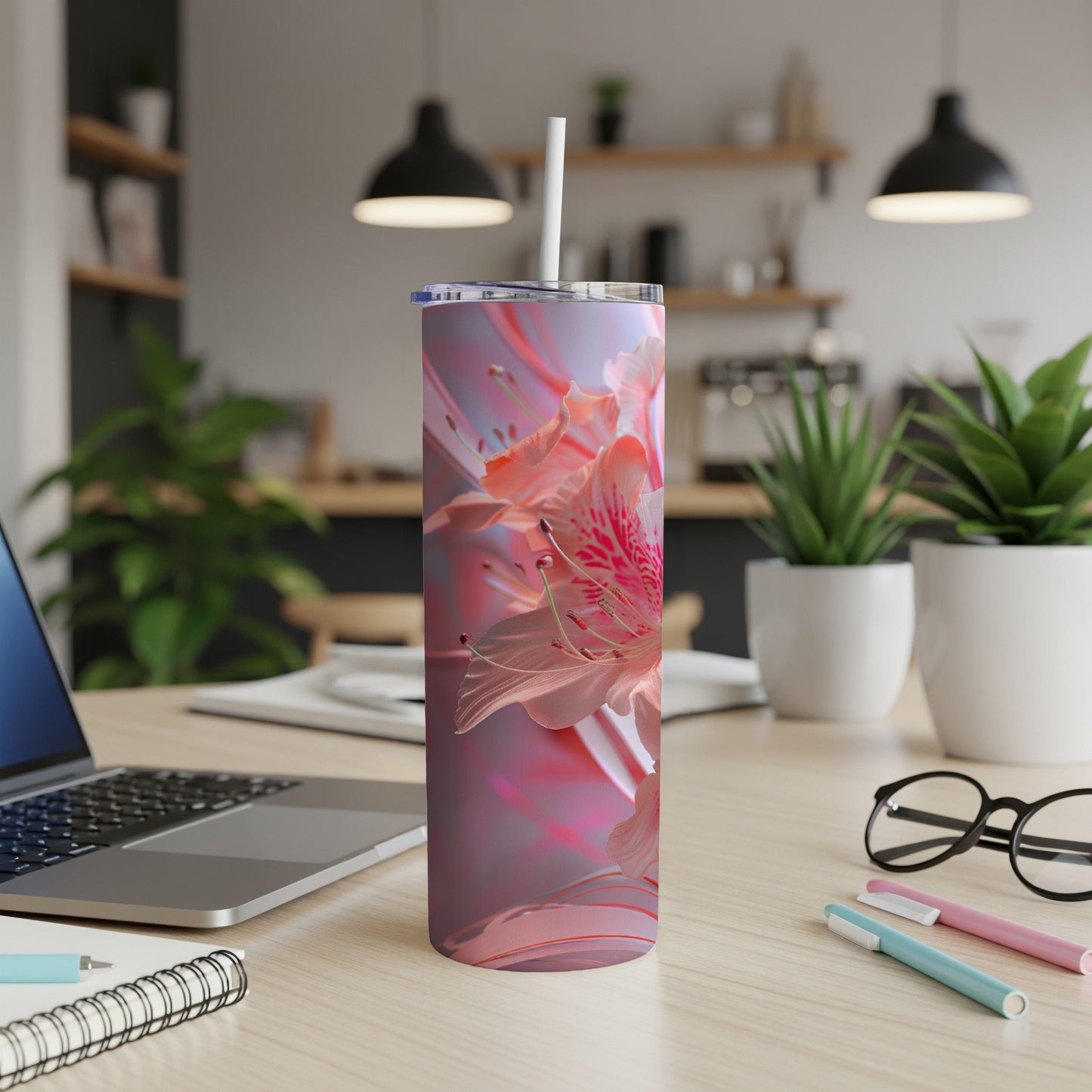 Pink floral design on a stainless steel tumbler with a straw.