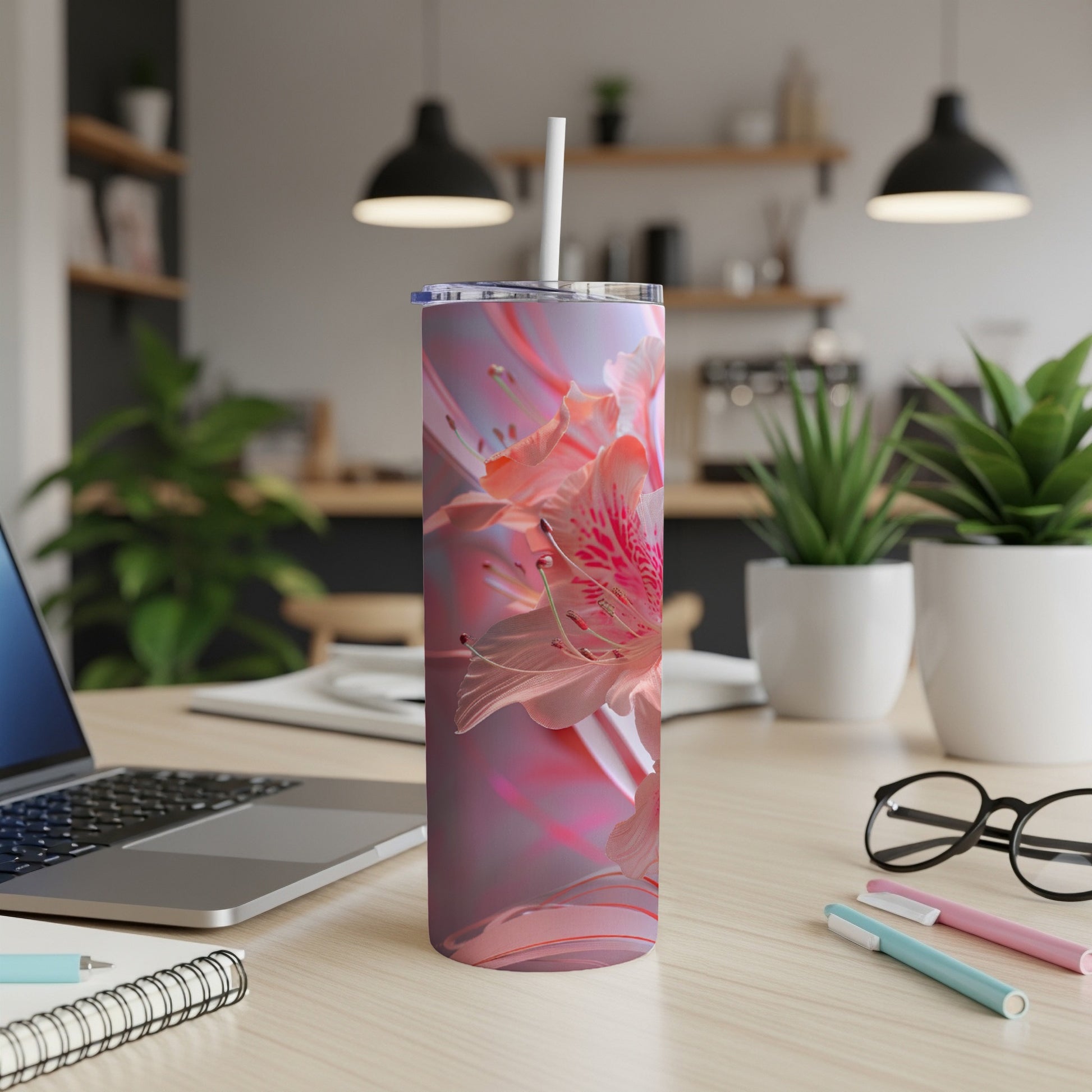 Pink floral design on a stainless steel tumbler with a straw.