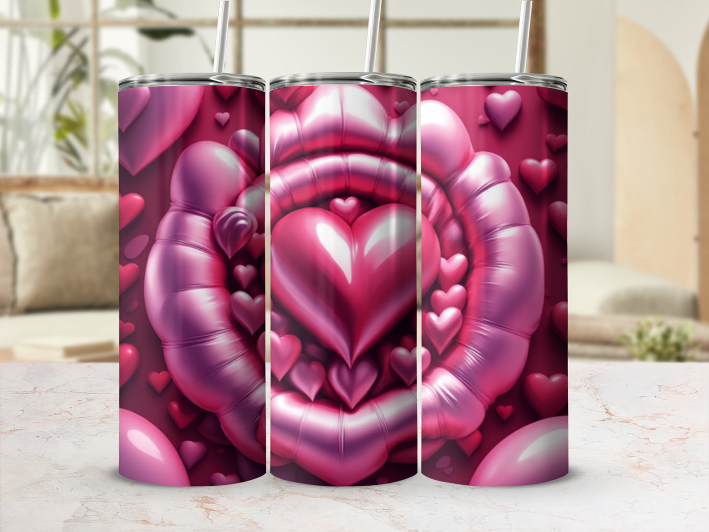 Three pink heart-shaped tumblers with straws, arranged in a row.
