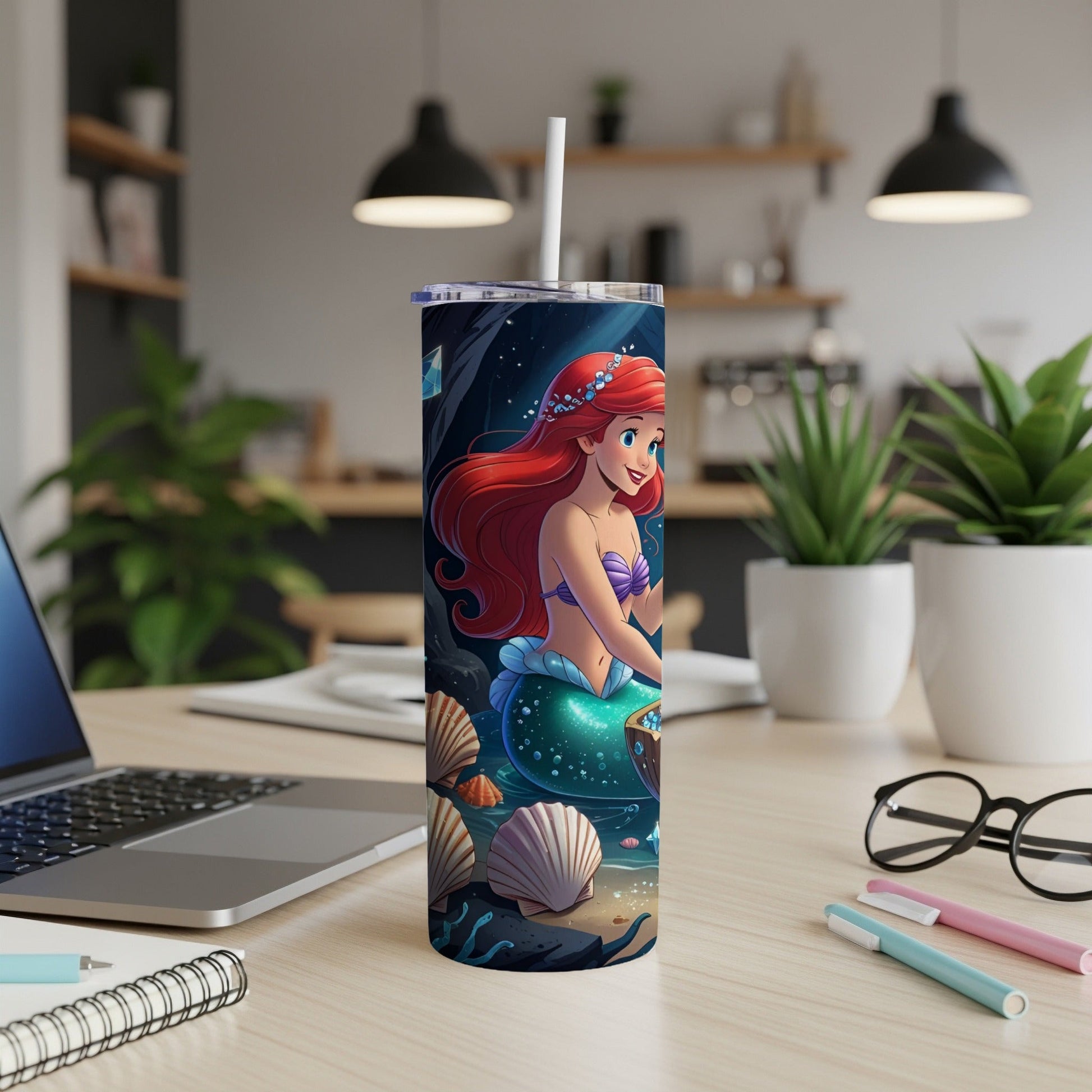 Ariel the mermaid on a white tumbler with seashells.