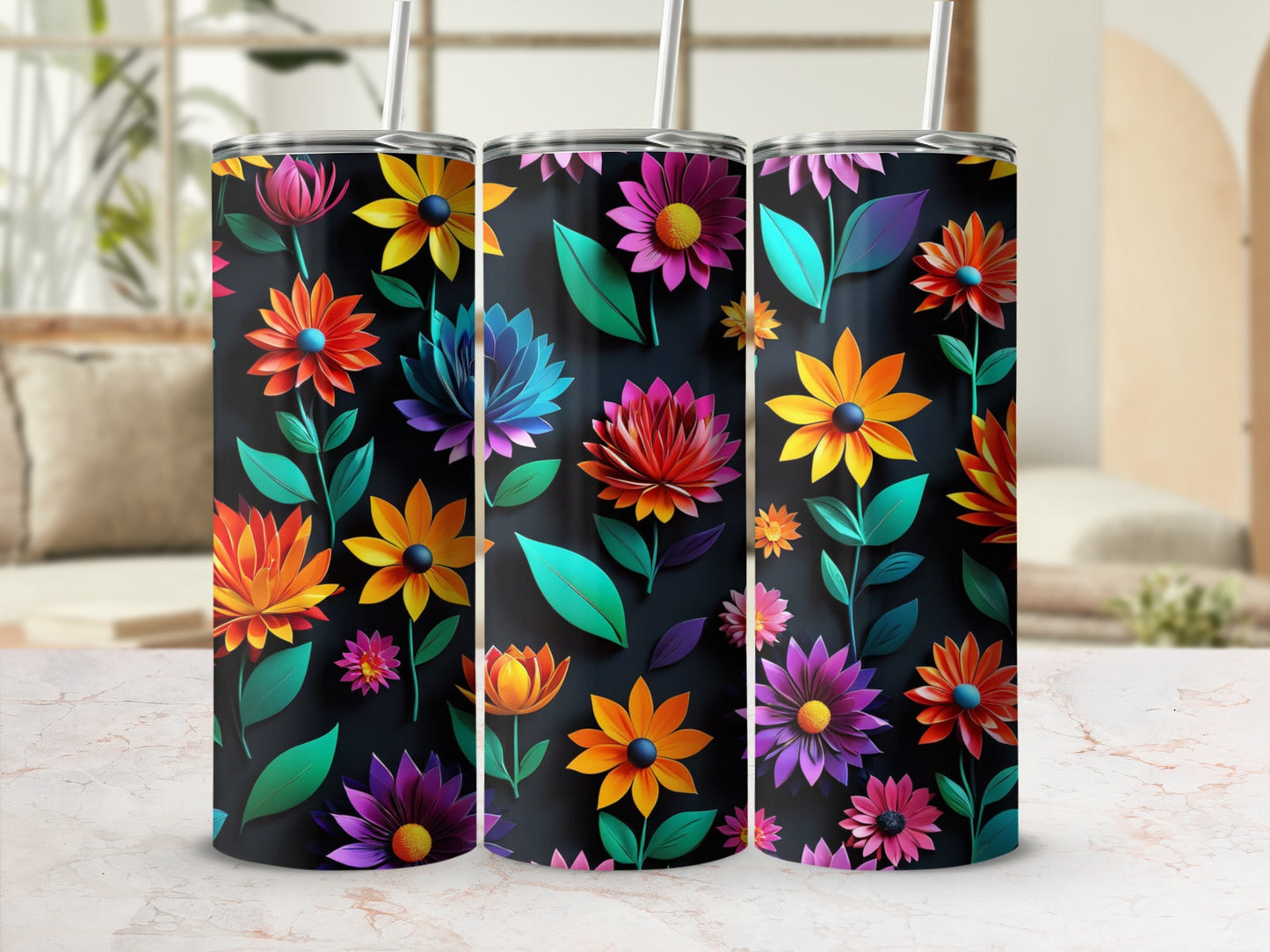 Three tumblers with vibrant floral patterns on a dark background.