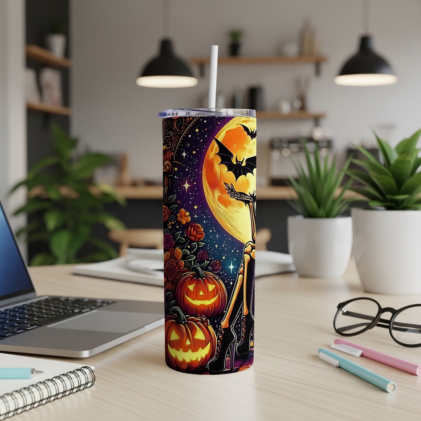 Tall tumbler with Halloween design of pumpkins, skeleton legs, bats, and moon.