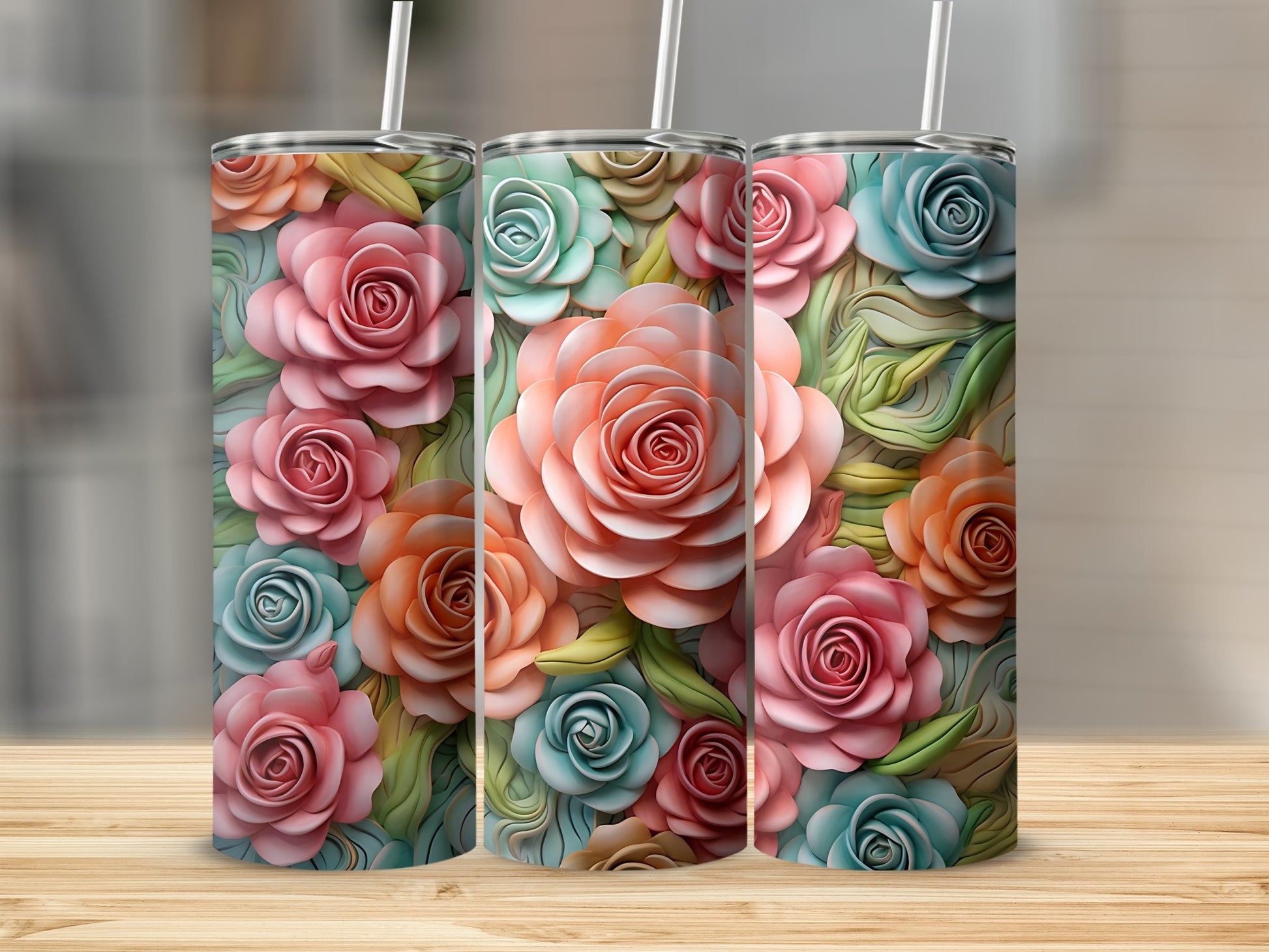 Three floral tumblers with pastel roses and leaves on a wooden surface.