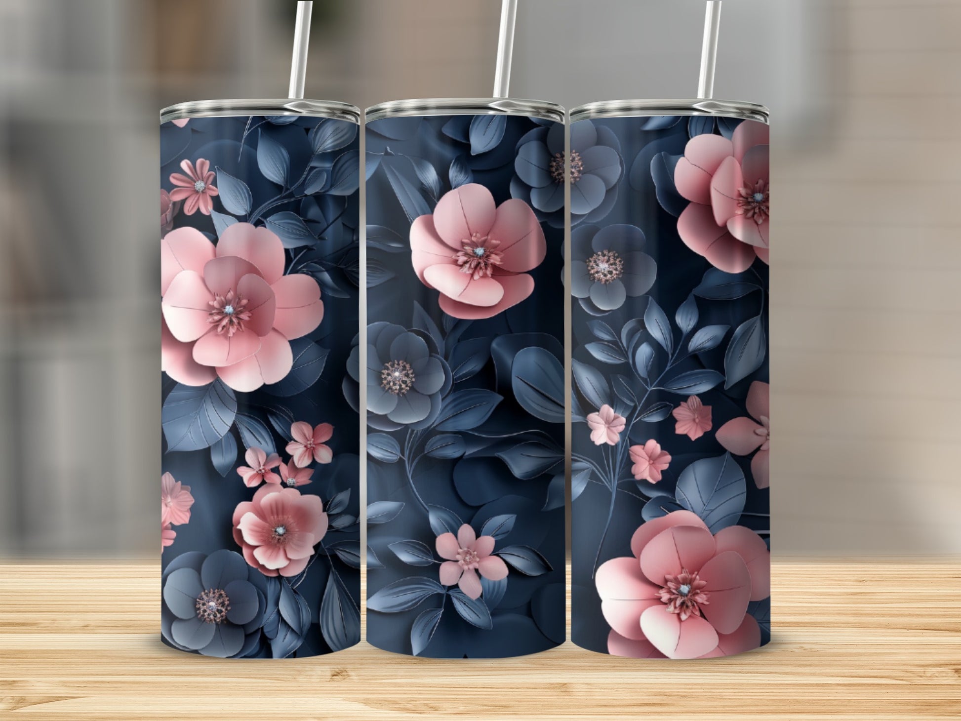 Three tumblers with pink and blue floral patterns on a wooden surface.