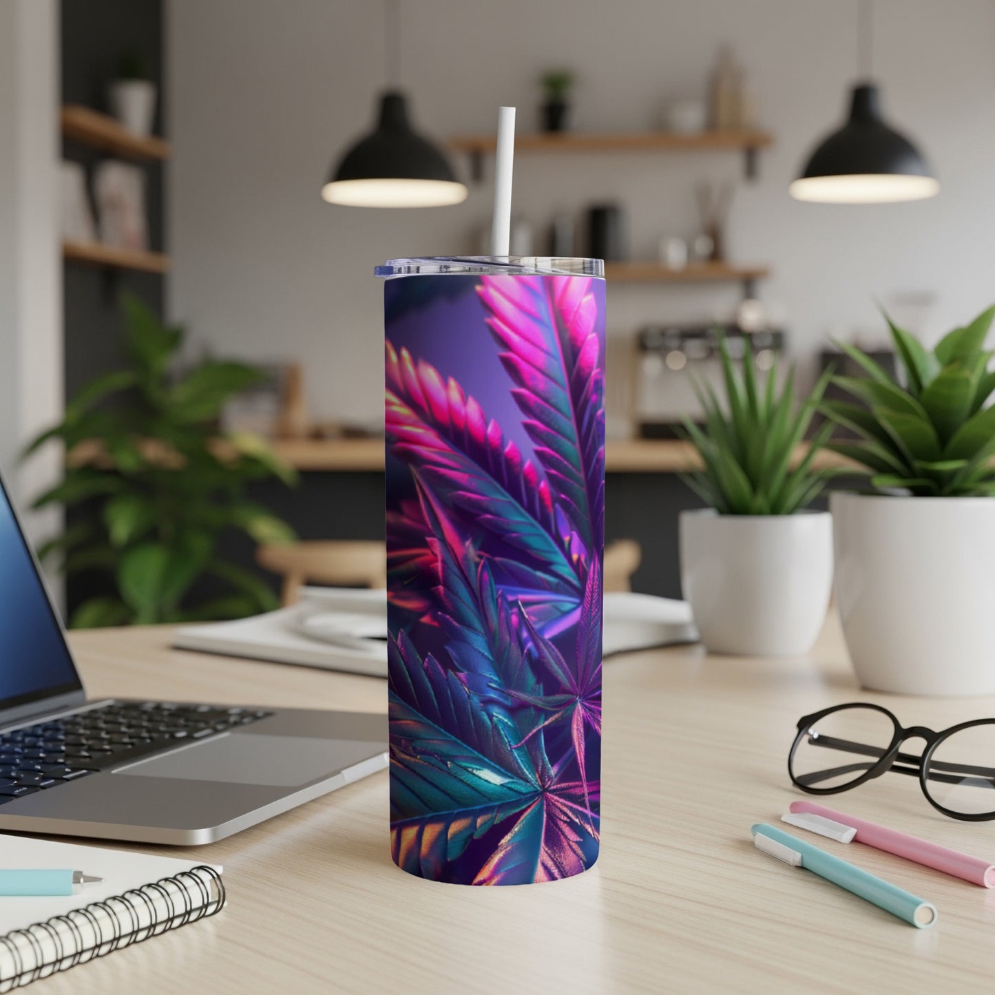 Purple and pink cannabis leaves design on a white tumbler with a straw.