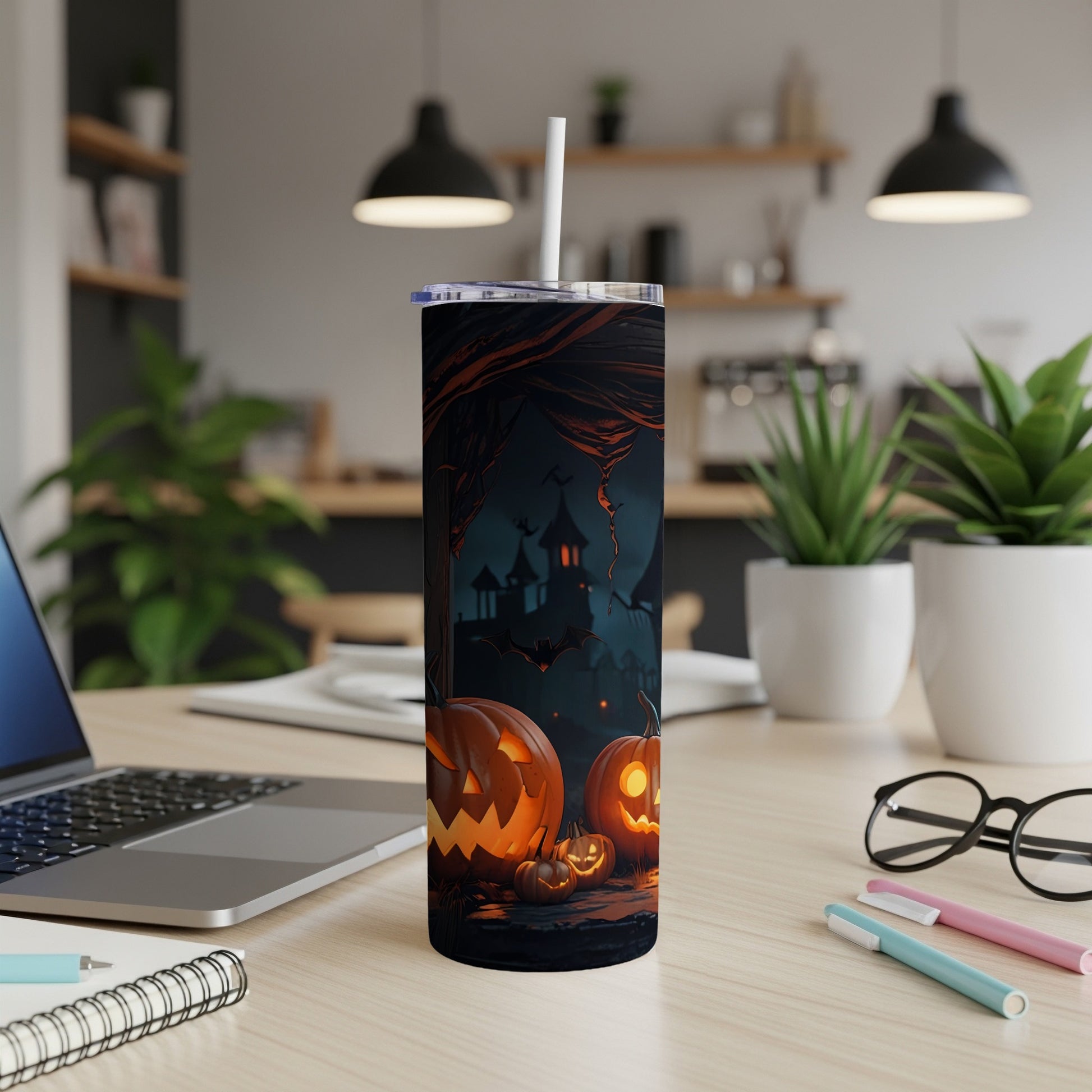 Tumbler with Halloween design: carved pumpkins, bats, and spooky castle.
