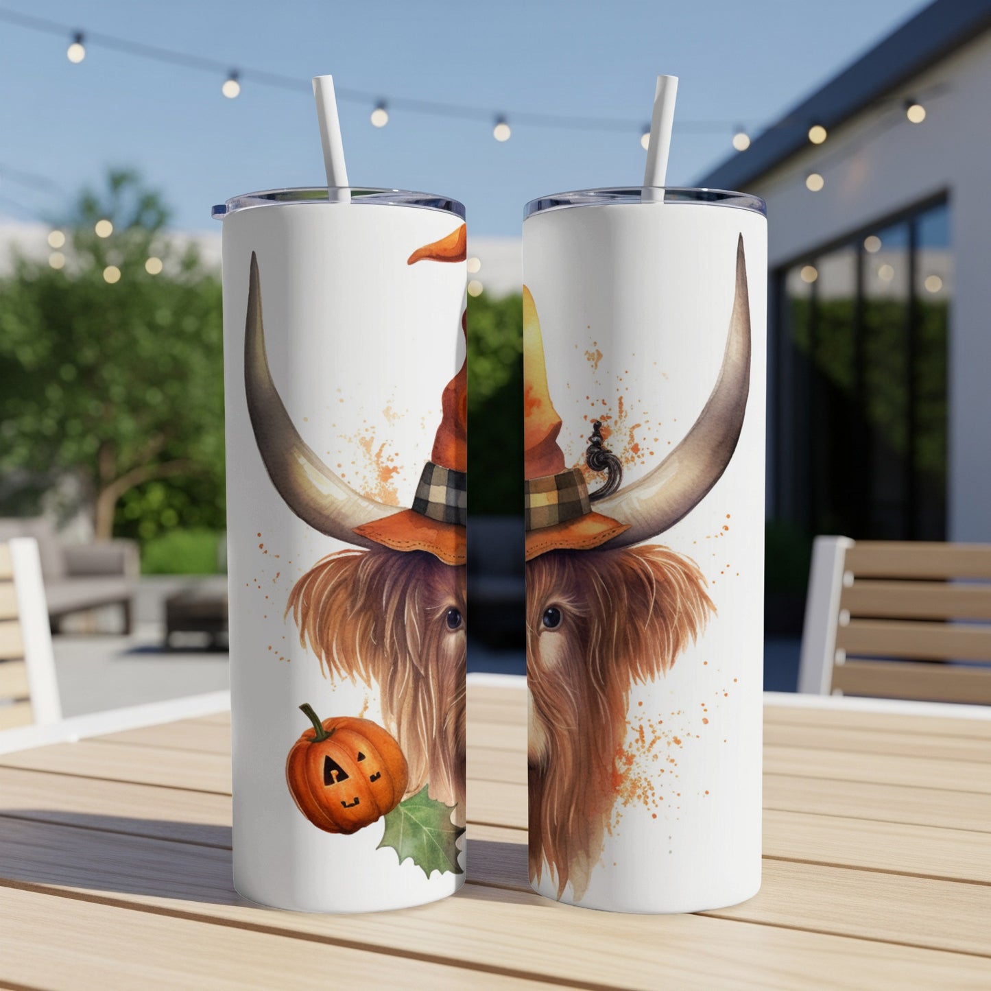 Highland cow wearing a witch hat and a Halloween pumpkin illustration on a tumbler.