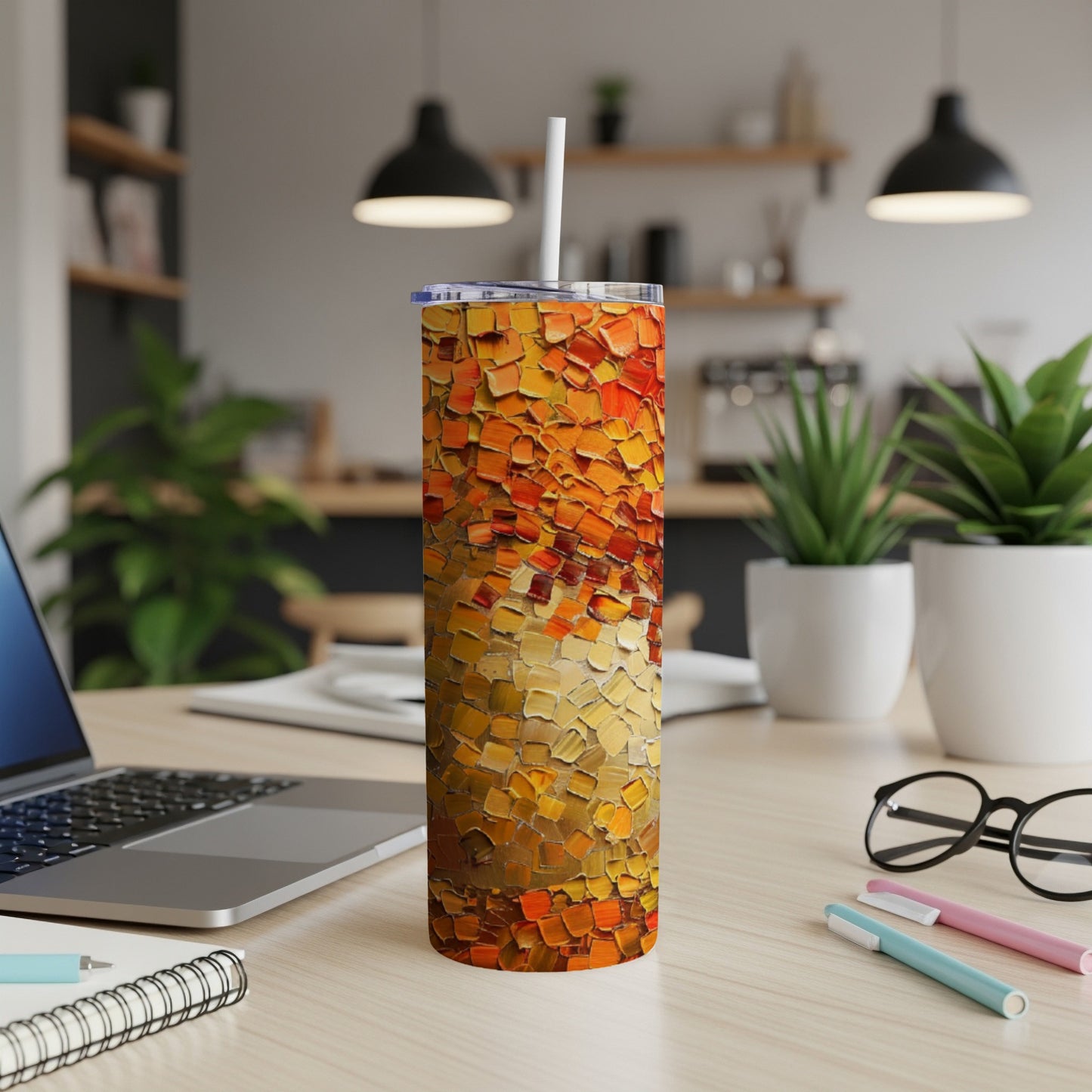Tall tumbler with textured orange, yellow, and red abstract art design.