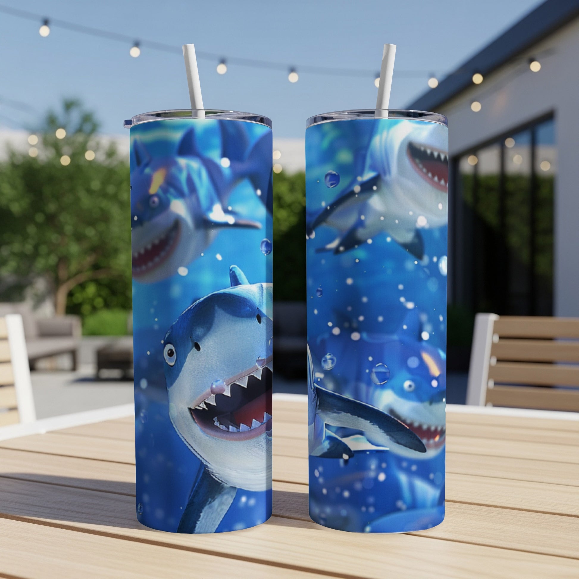 Two tumblers with cartoon sharks swimming underwater with bubbles.