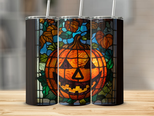 Stained glass pumpkin tumbler with autumn leaves design.