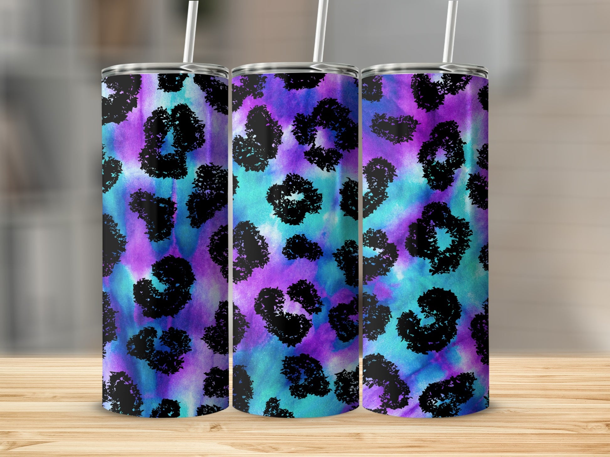 Three tumblers with purple, blue, and teal tie-dye leopard print.