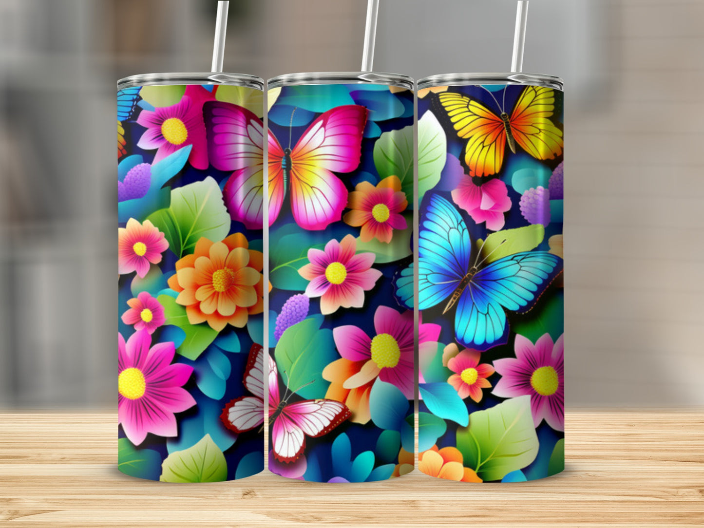 Three tumblers with colorful butterfly and floral designs.