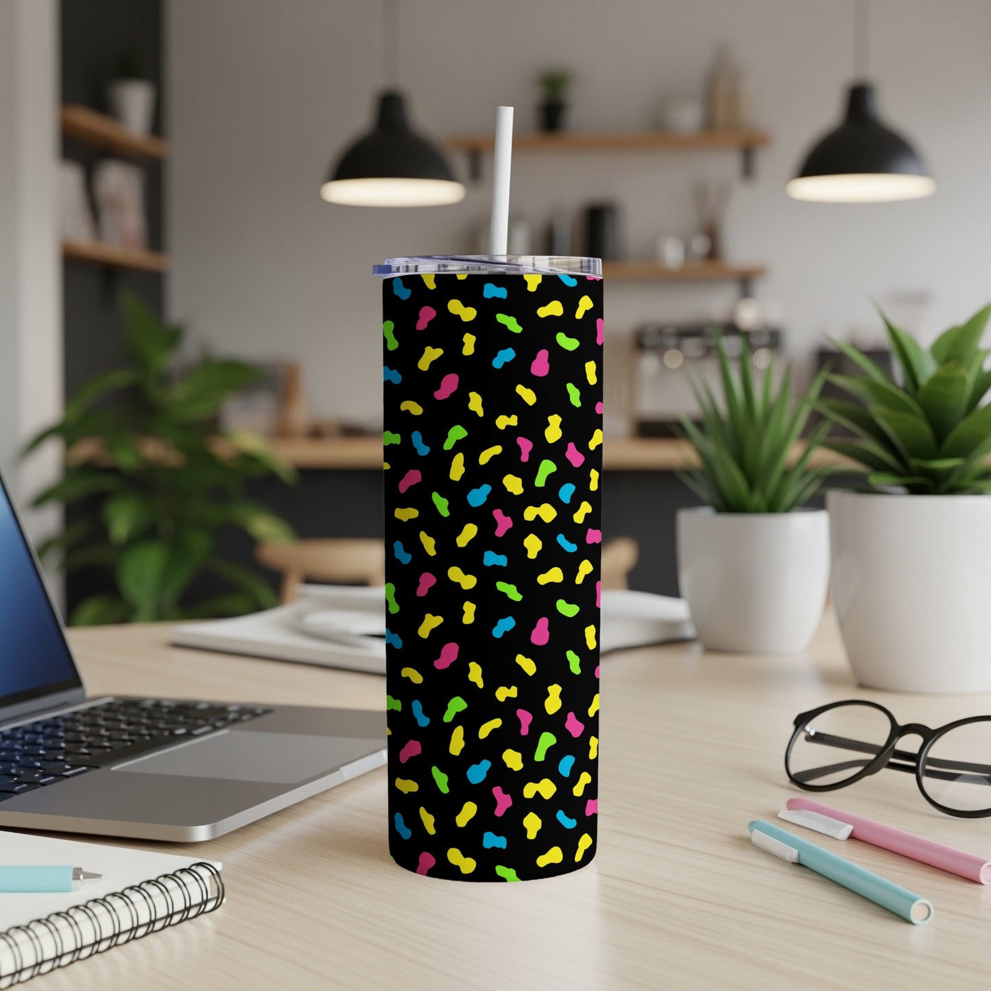 Travel tumbler with a neon confetti pattern on black.