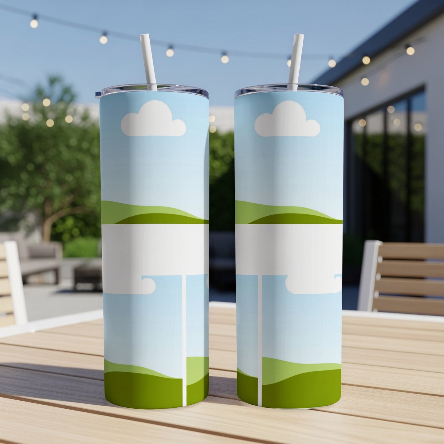 Two tumblers with a blue sky, clouds, and green hills design.