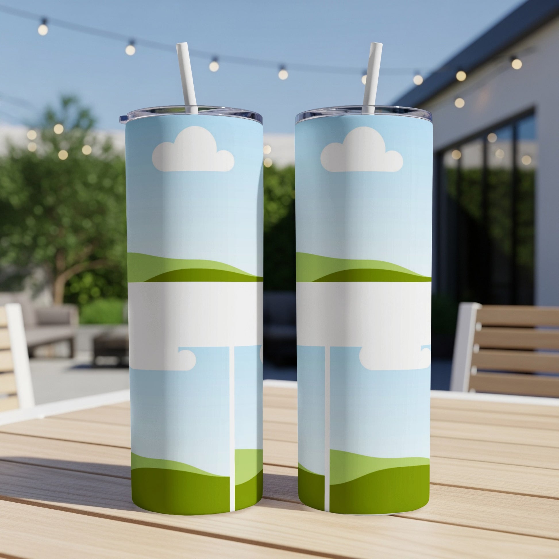 Two tumblers with a blue sky, clouds, and green hills design.