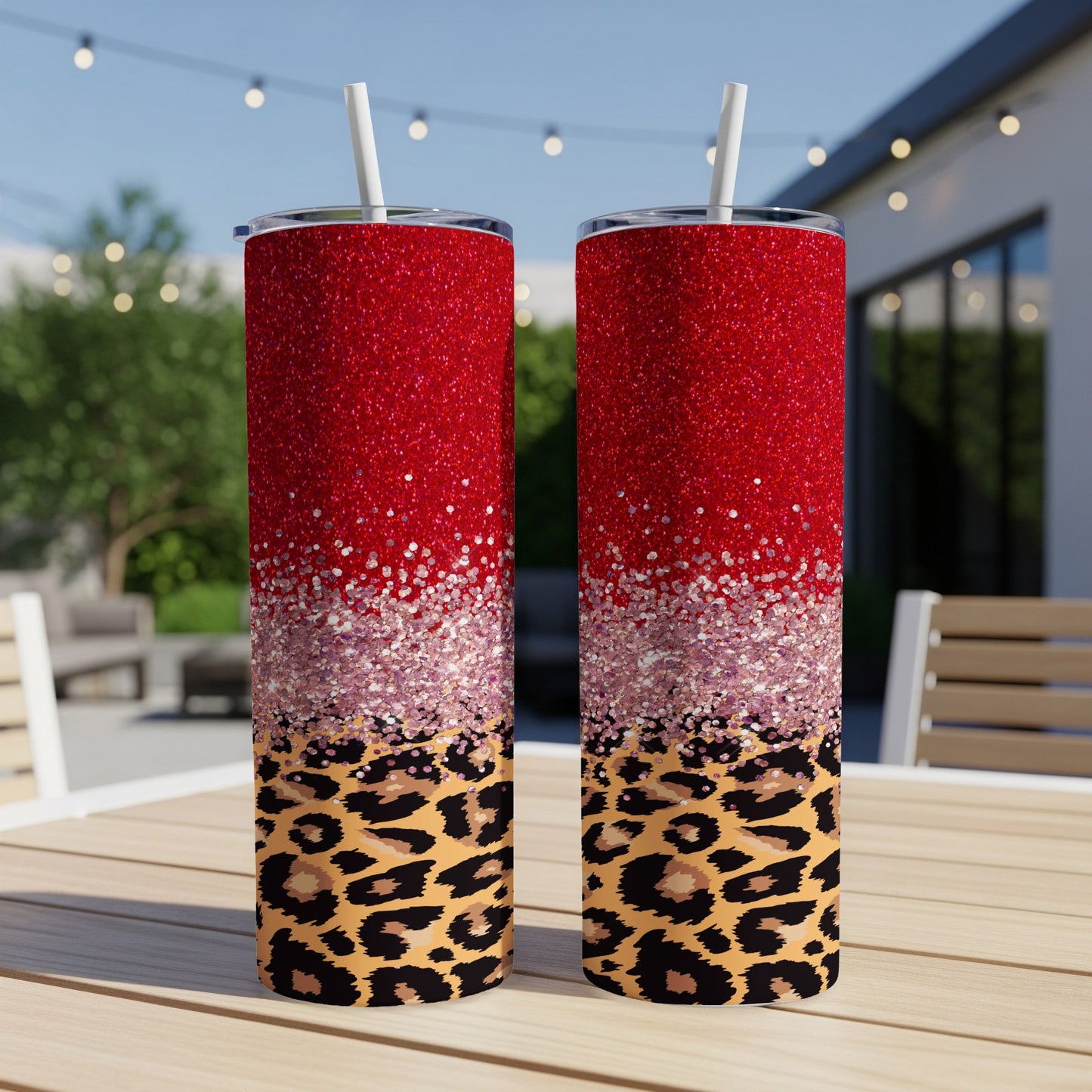 Two red glitter tumblers with leopard print below, on a table.