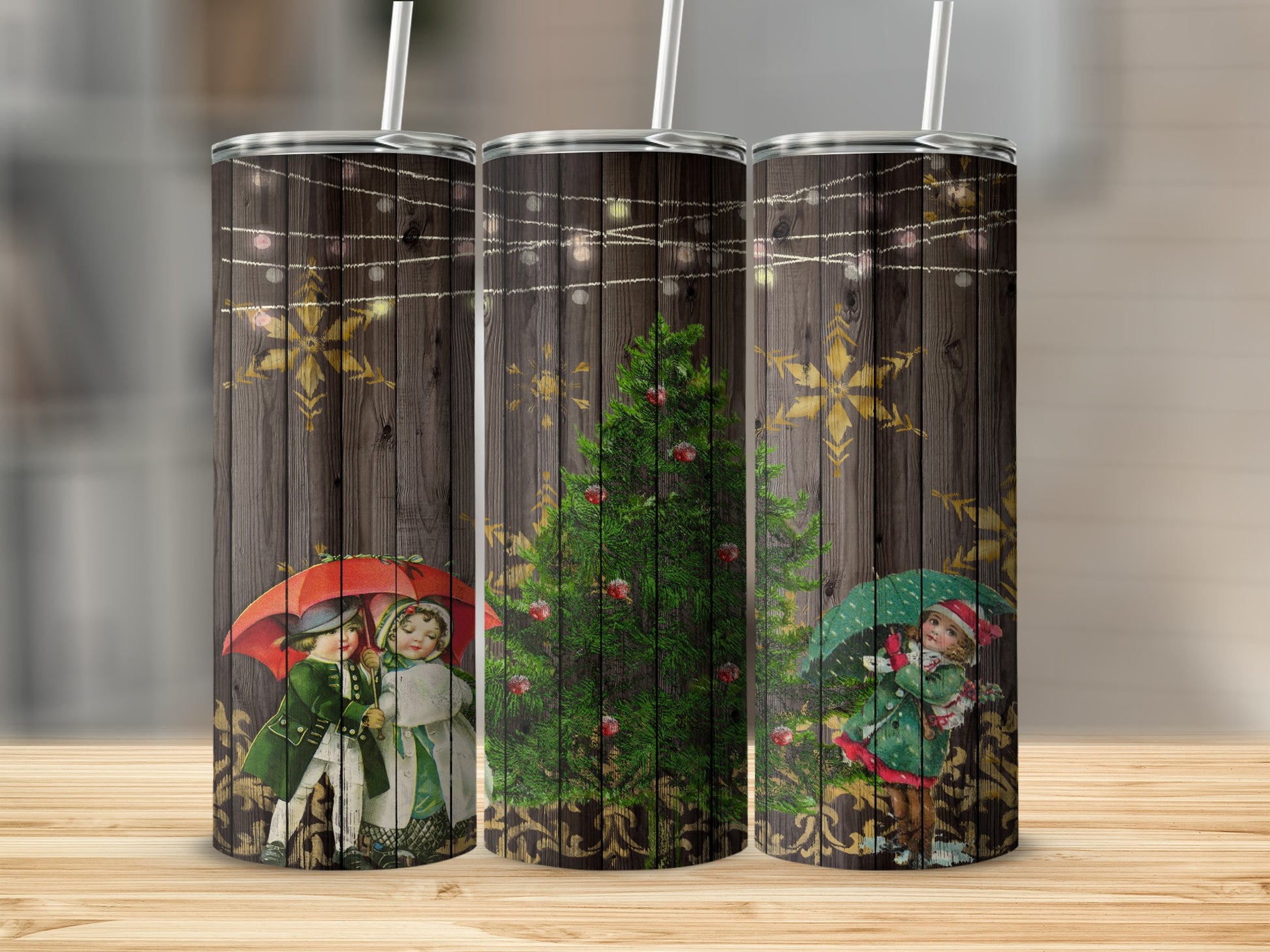 Three tumblers with a festive Christmas design featuring children and a decorated tree.