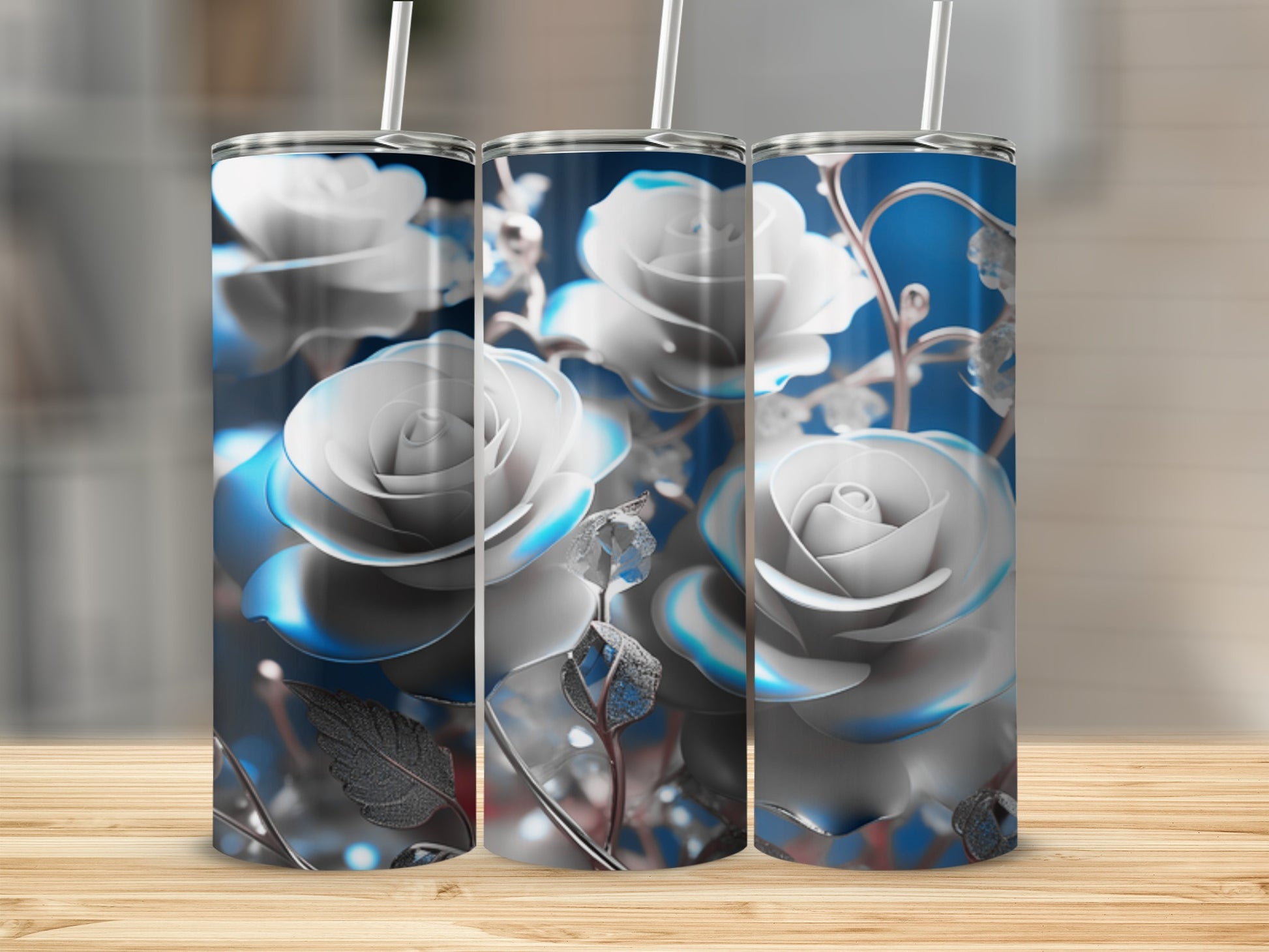 Three tumblers with blue and white roses, on a wooden surface.