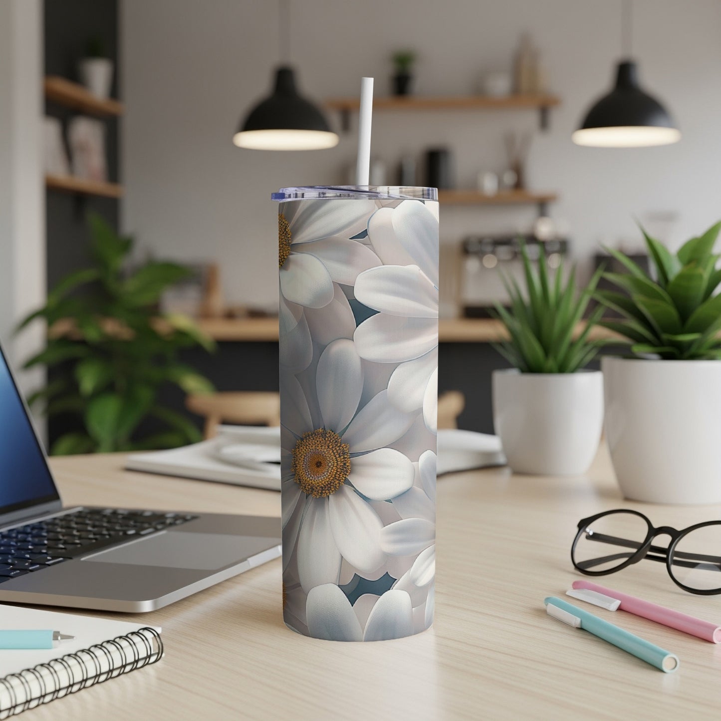White daisy floral pattern on a stainless steel tumbler with straw.