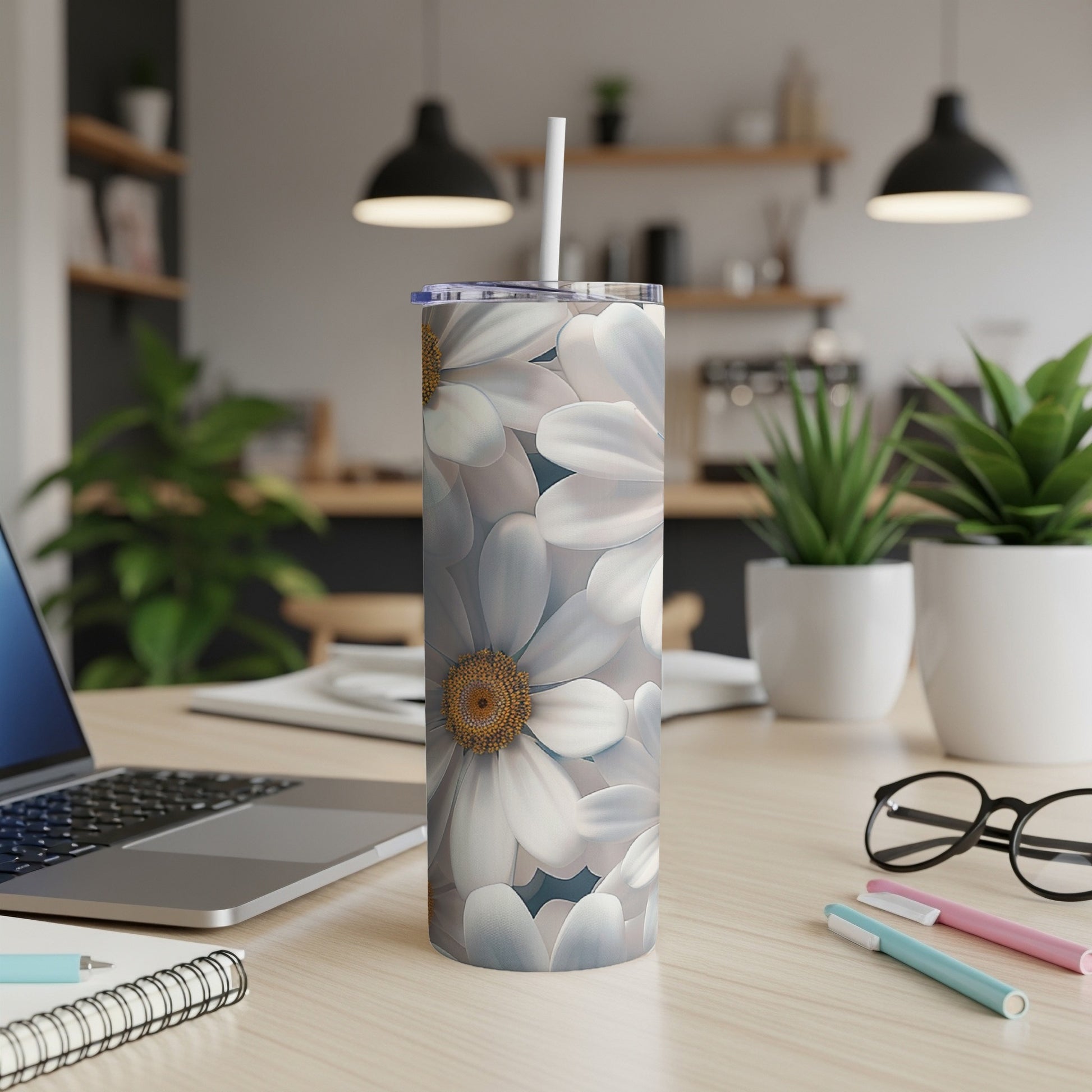 White daisy floral pattern on a stainless steel tumbler with straw.