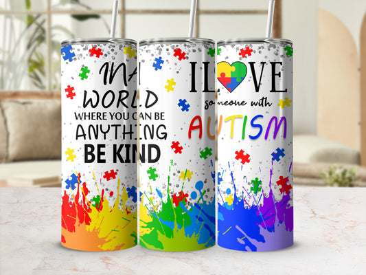 Tumblers with colorful puzzle piece designs and "In a world where you can be anything be kind" text.