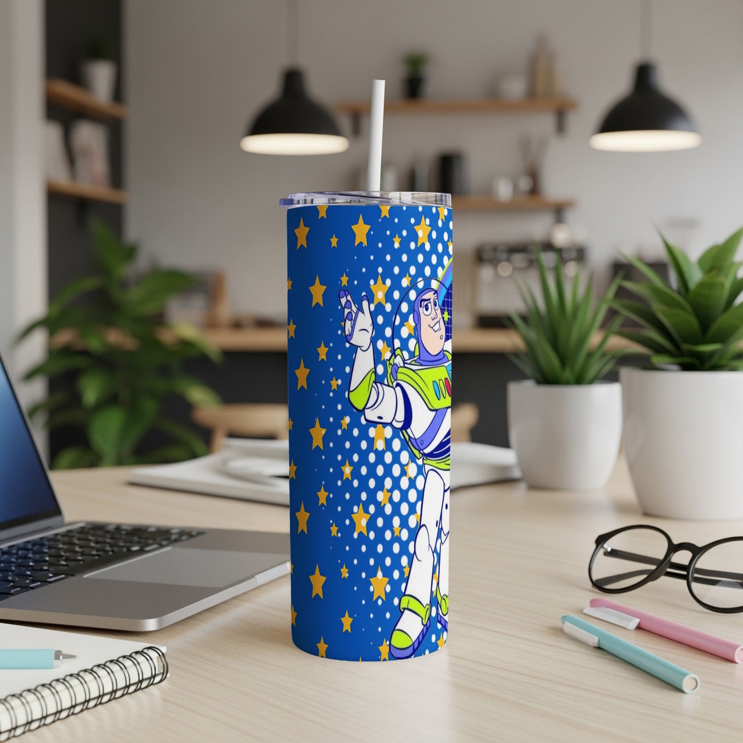 Blue tumbler with Buzz Lightyear and yellow stars, straw inserted.