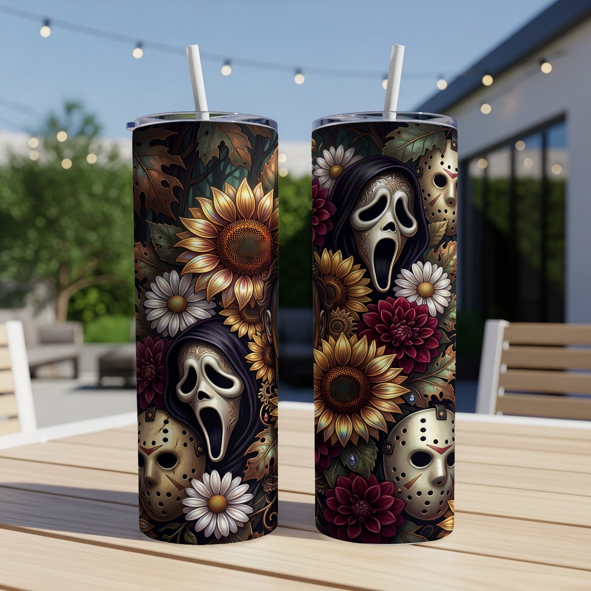 Two tumblers with horror masks and flowers, displayed outdoors on a table.