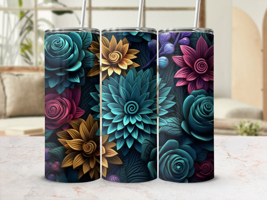 Three floral tumblers with colorful embossed designs against a blurred background.