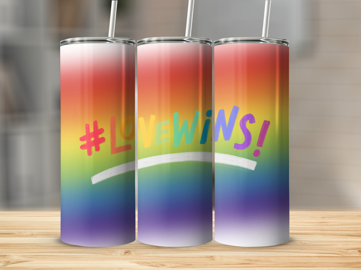 Rainbow gradient tumbler with "#LOVEWINS!" text and straw.