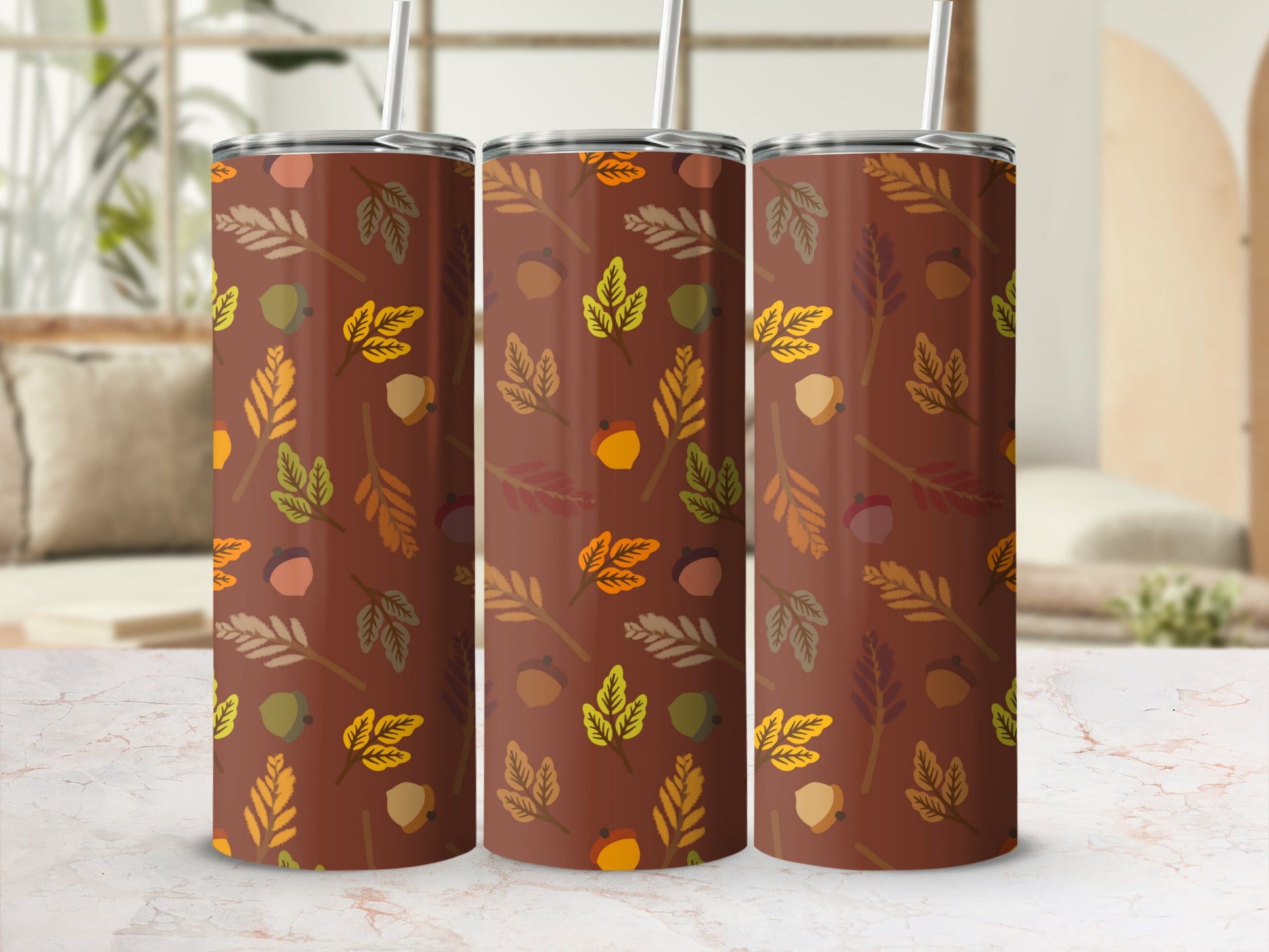 Three brown tumblers with a fall leaf and acorn pattern.