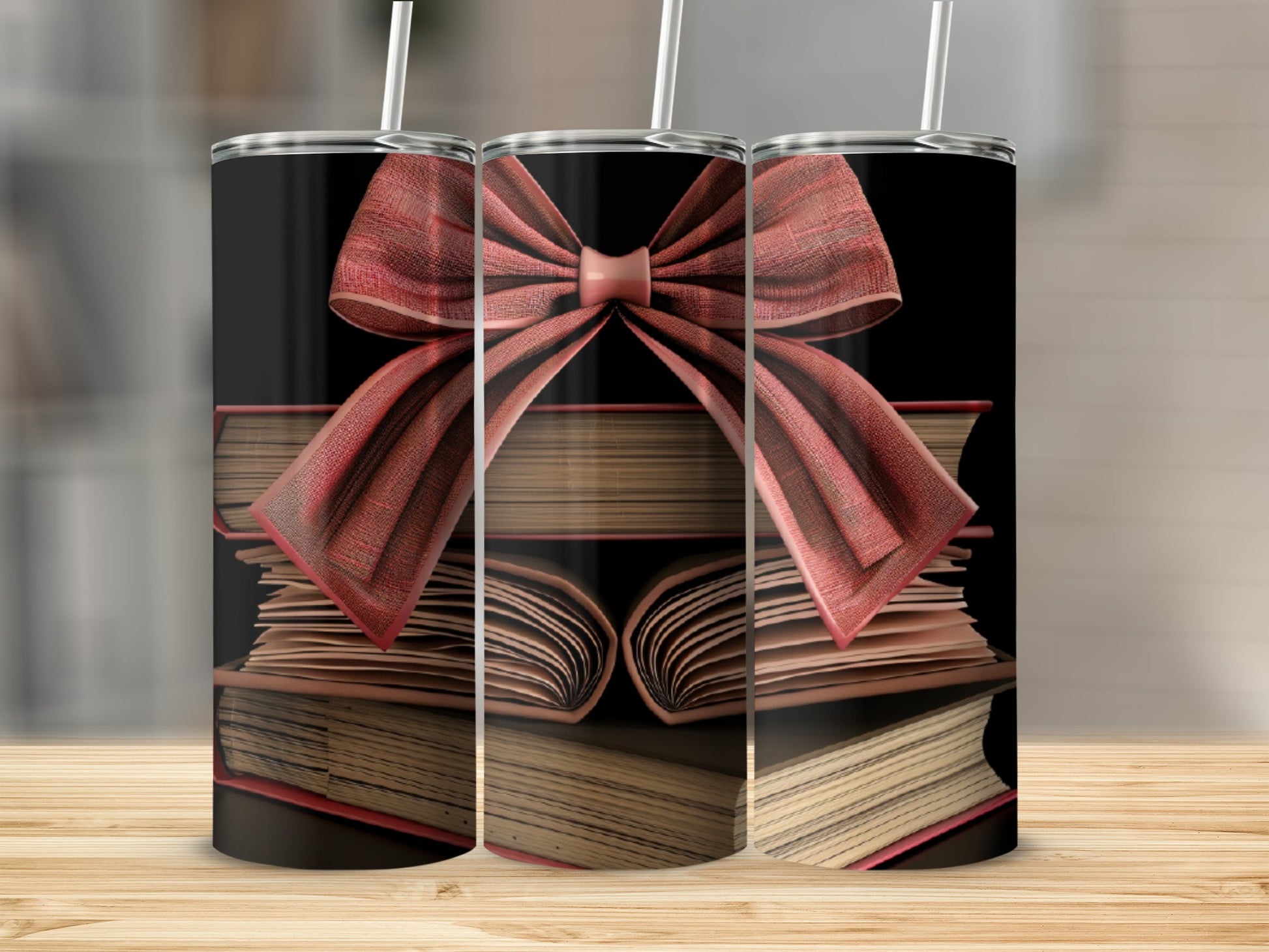 Three tumblers with stacked books and red ribbon bows.