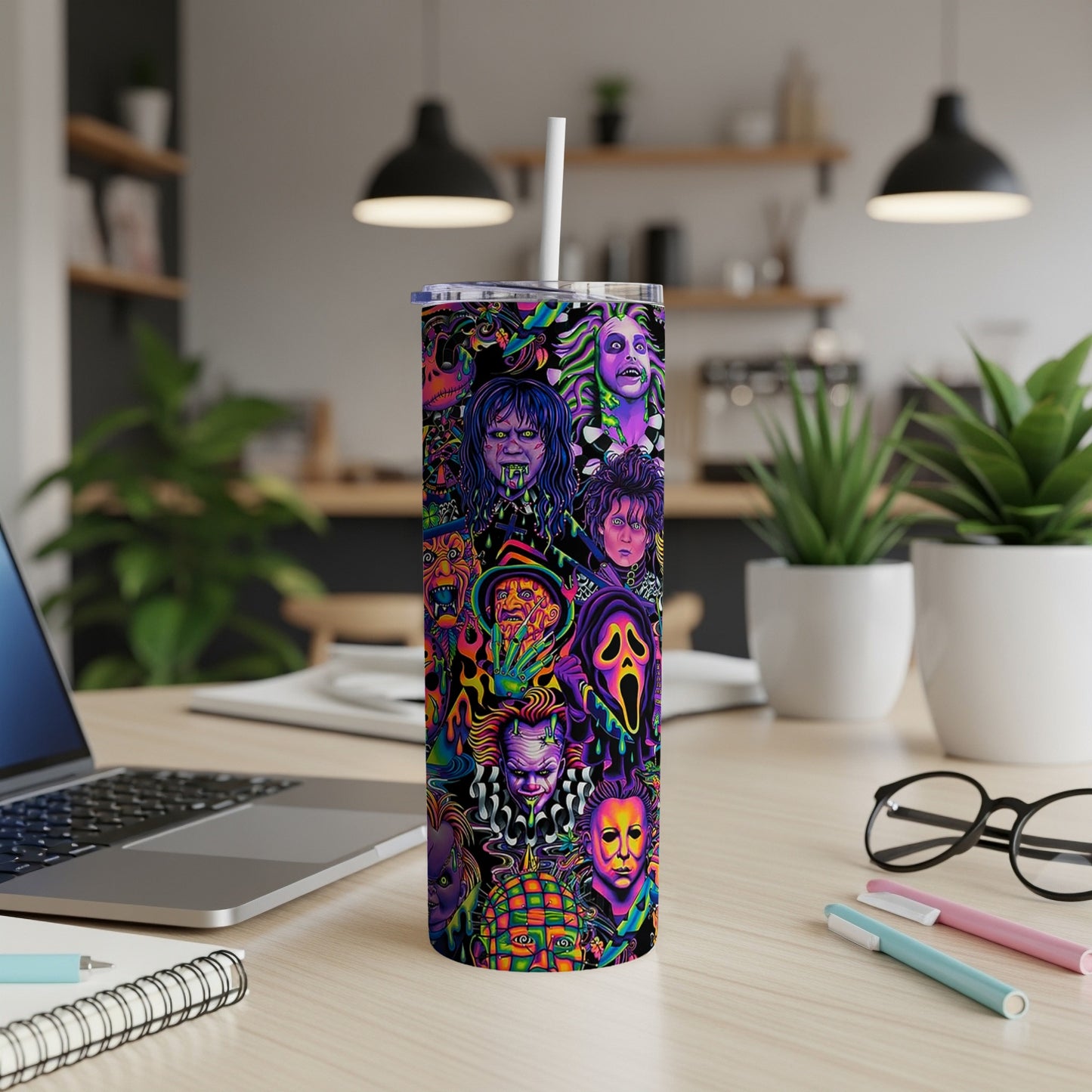 Tumbler with a collage of horror movie villains and characters in vibrant colors.