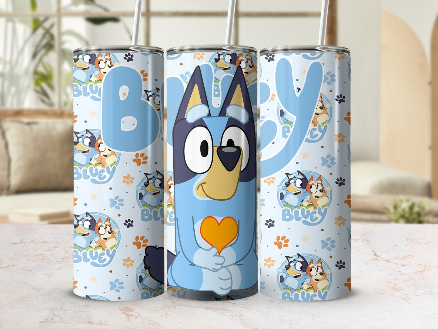 Bluey character on a blue patterned tumbler with a straw.