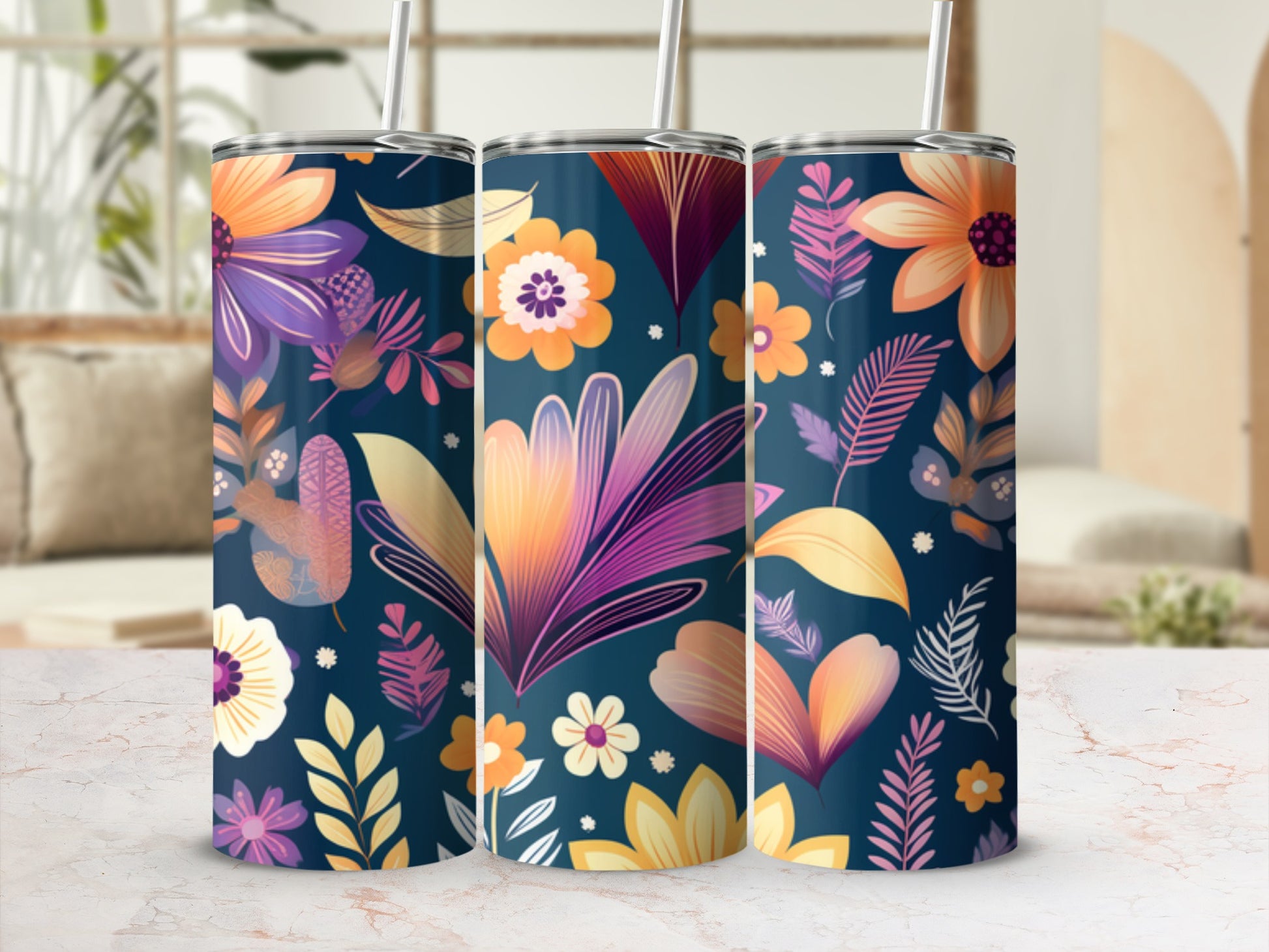 Three tumblers with a floral pattern on a marbled surface.
