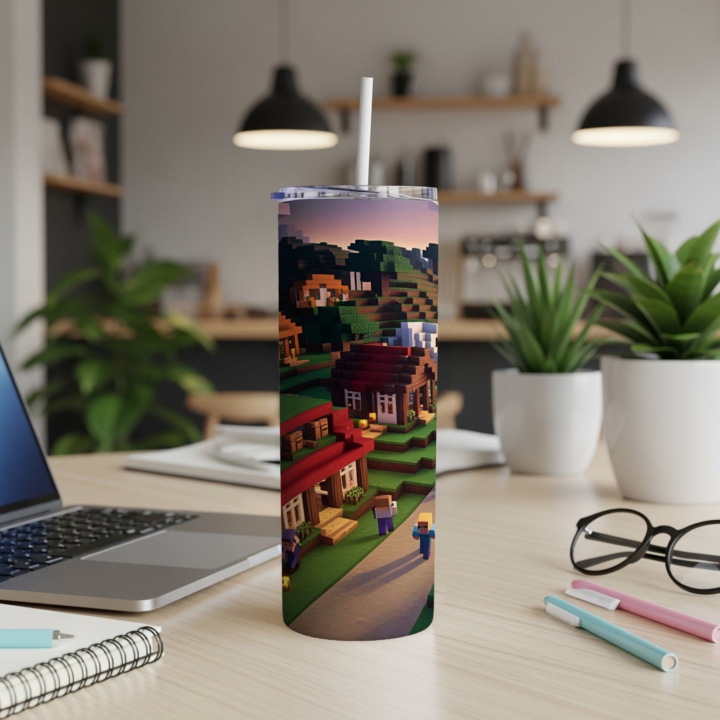 Minecraft-themed tumbler featuring pixelated houses, trees, and characters on a desk.