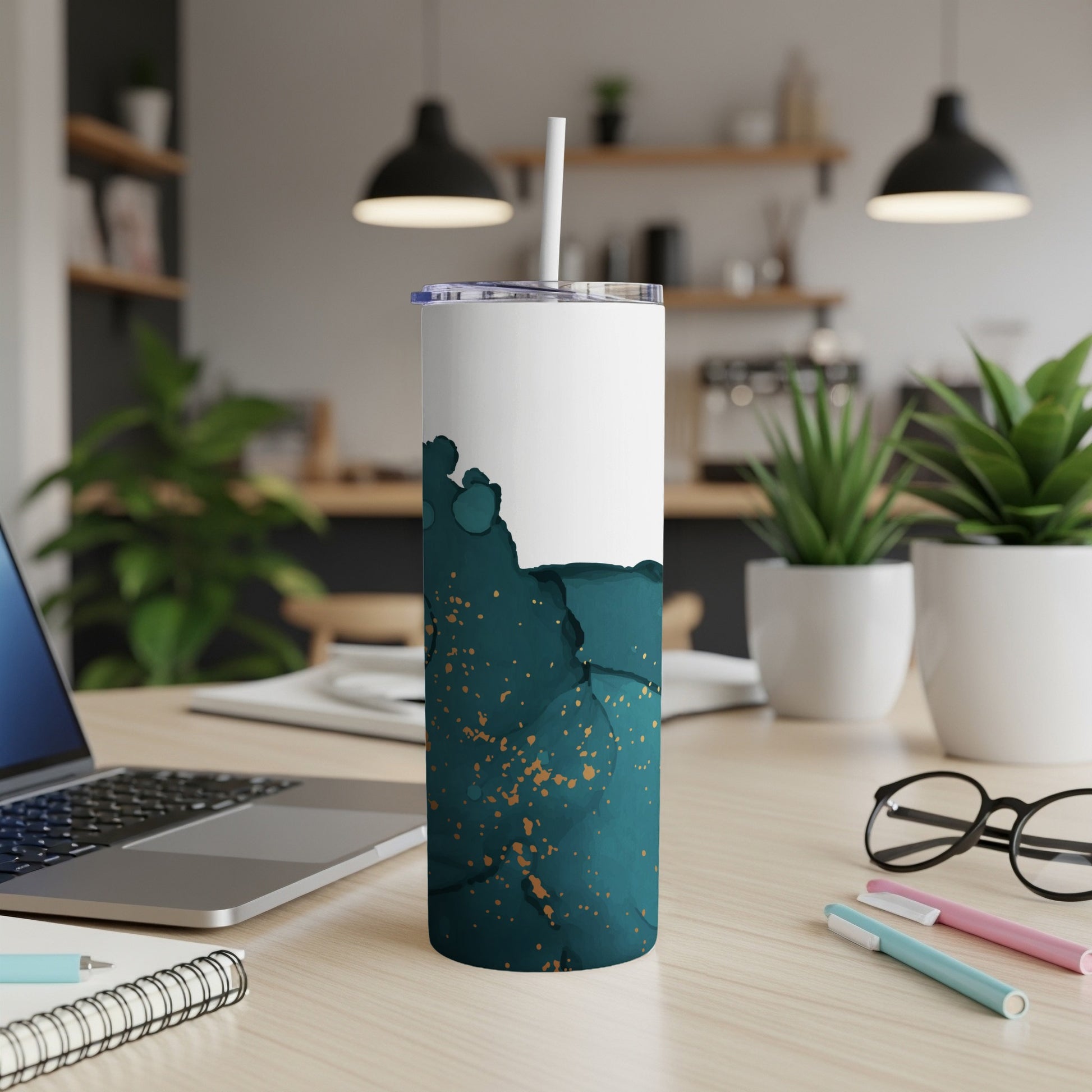 White and teal abstract tumbler with gold speckles and straw.