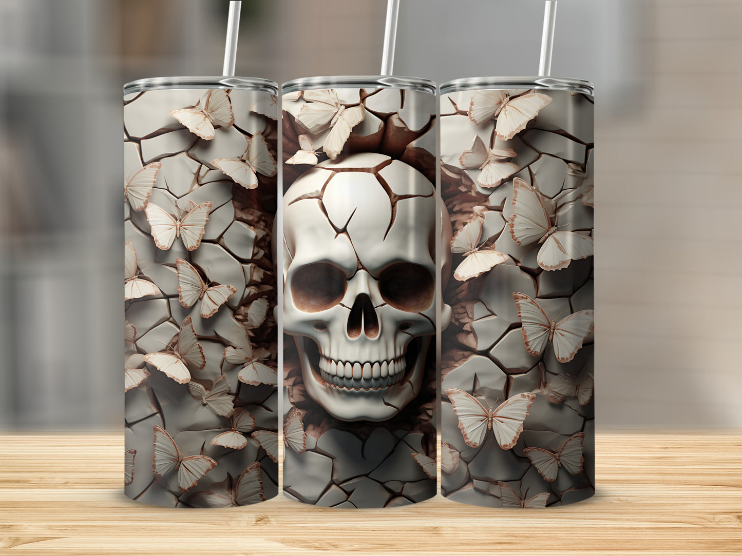 Three tumblers featuring a cracked skull with butterflies against a textured background.