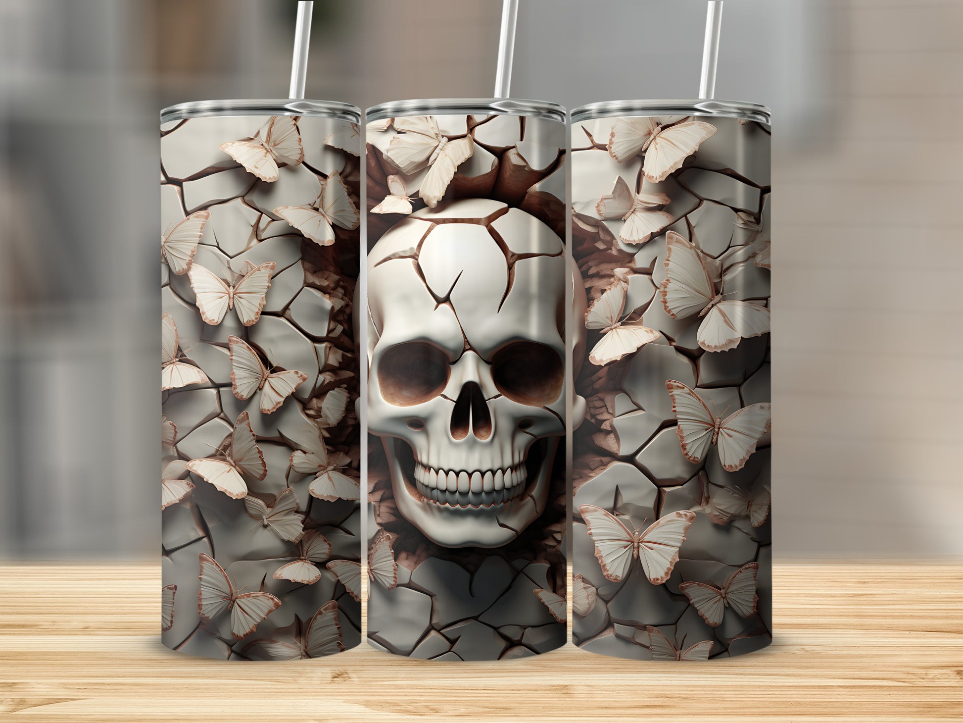 Three tumblers featuring a cracked skull with butterflies against a textured background.